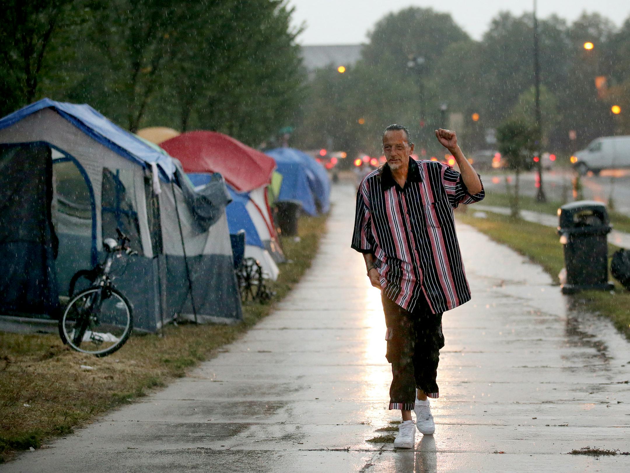 James Cross, the founder of the street outreach group Natives Against Heroin, spent nearly half of his life in prison for drug-related crimes but is working hard now to help people in his Native American community, particularly the poor and those with substance abuse problems. Here, Cross walks in the rain while patrolling a growing homeless encampment Monday, Aug. 27, 2018, in south Minneapolis, MN.] DAVID JOLES ï david.joles@startribune.com James Cross, the founder of the street outreach group