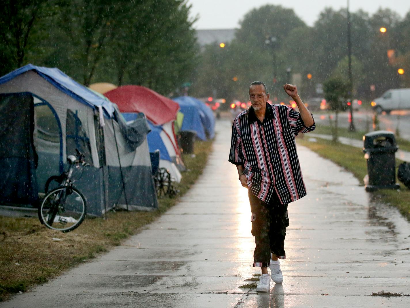 James Cross, the founder of the street outreach group Natives Against Heroin, spent nearly half of his life in prison for drug-related crimes but is working hard now to help people in his Native American community, particularly the poor and those with substance abuse problems. Here, Cross walks in the rain while patrolling a growing homeless encampment Monday, Aug. 27, 2018, in south Minneapolis, MN.] DAVID JOLES ï david.joles@startribune.com James Cross, the founder of the street outreach group