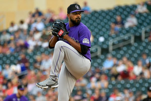 Colorado Rockies pitcher German Marquez winds up during the first inning of the team's baseball game against the Minnesota Twins, Friday, June 24, 202