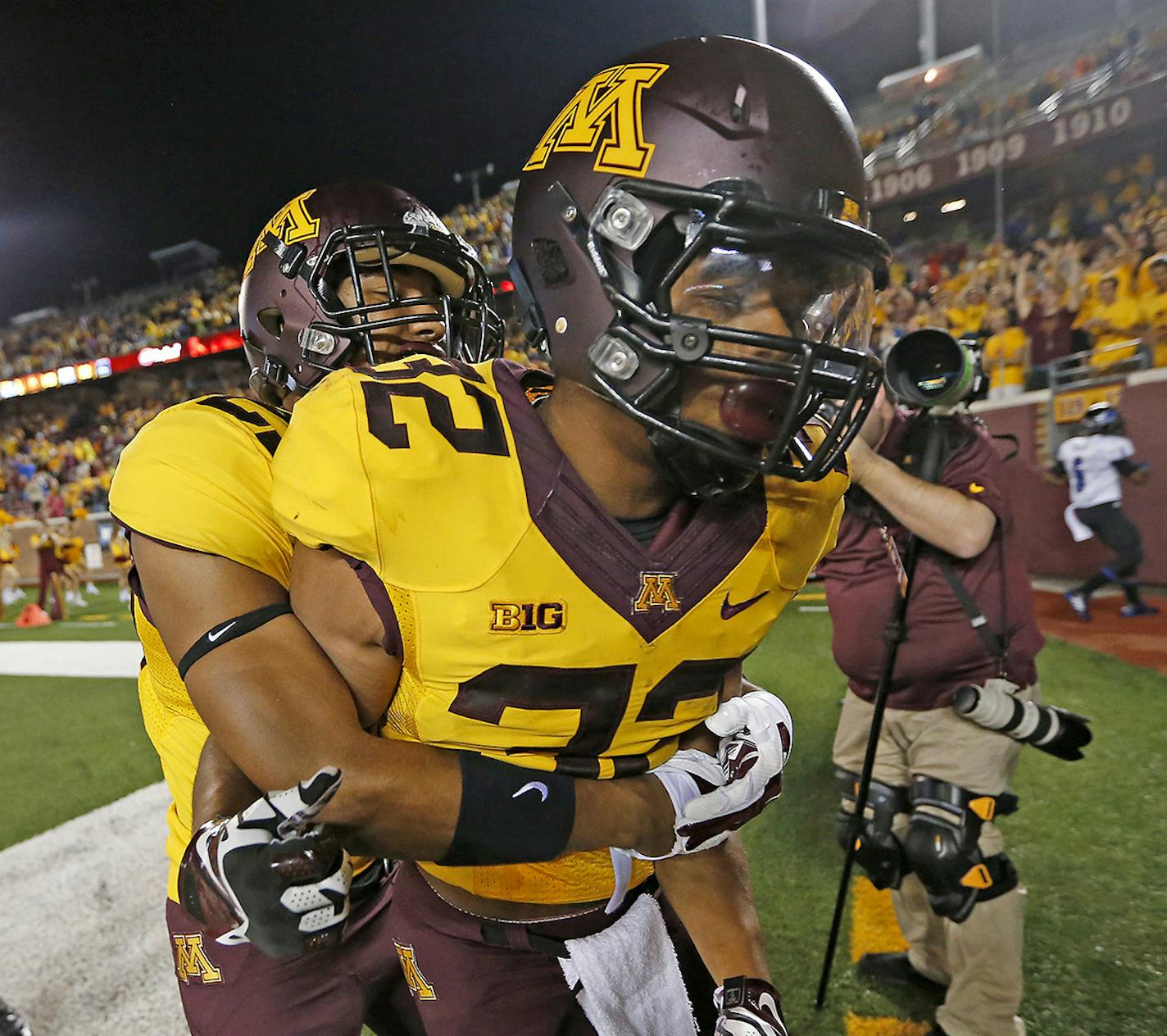 Minnesota running back Berkley Edwards was hugged by teammates after he ran for a touchdown during the fourth quarter of the opening game against Eastern Illinois, Thursday, August 28, 2014 in Minneapolis, MN. ] (ELIZABETH FLORES/STAR TRIBUNE) ELIZABETH FLORES &#x2022; eflores@startribune.com