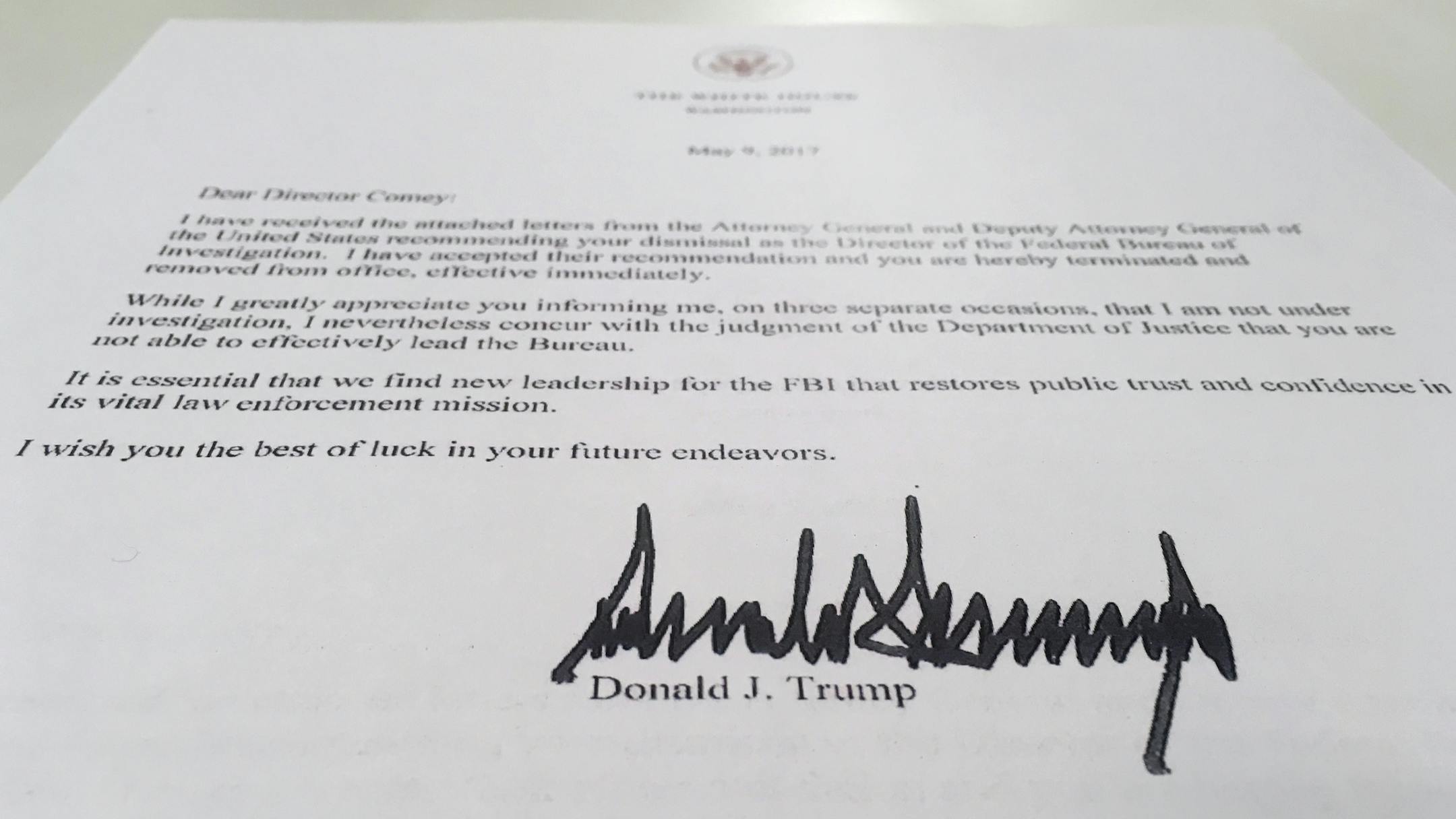 The termination letter from President Donald Trump to FBI Director James Comey is photographed in Washington, Tuesday, May 9, 2017. Trump abruptly fired Comey, ousting the nation's top law enforcement official in the midst of an investigation into whether Trump's campaign had ties to Russia's election meddling. In the letter to Comey, Trump said the firing was necessary to restore "public trust and confidence" in the FBI. (AP Photo/Jon Elswick