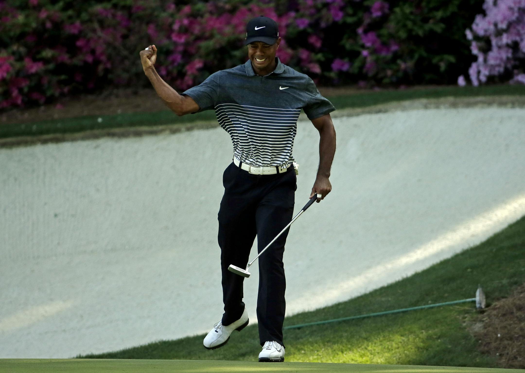 Tiger Woods reacts after a birdie on the 13th hole during the third round of the Masters golf tournament Saturday, April 11, 2015, in Augusta, Ga. (AP Photo/Chris Carlson)