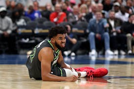 Karl-Anthony Towns (32) of the Minnesota Timberwolves reacts after being injured in the third quarter against the Washington Wizards at Capital One Ar