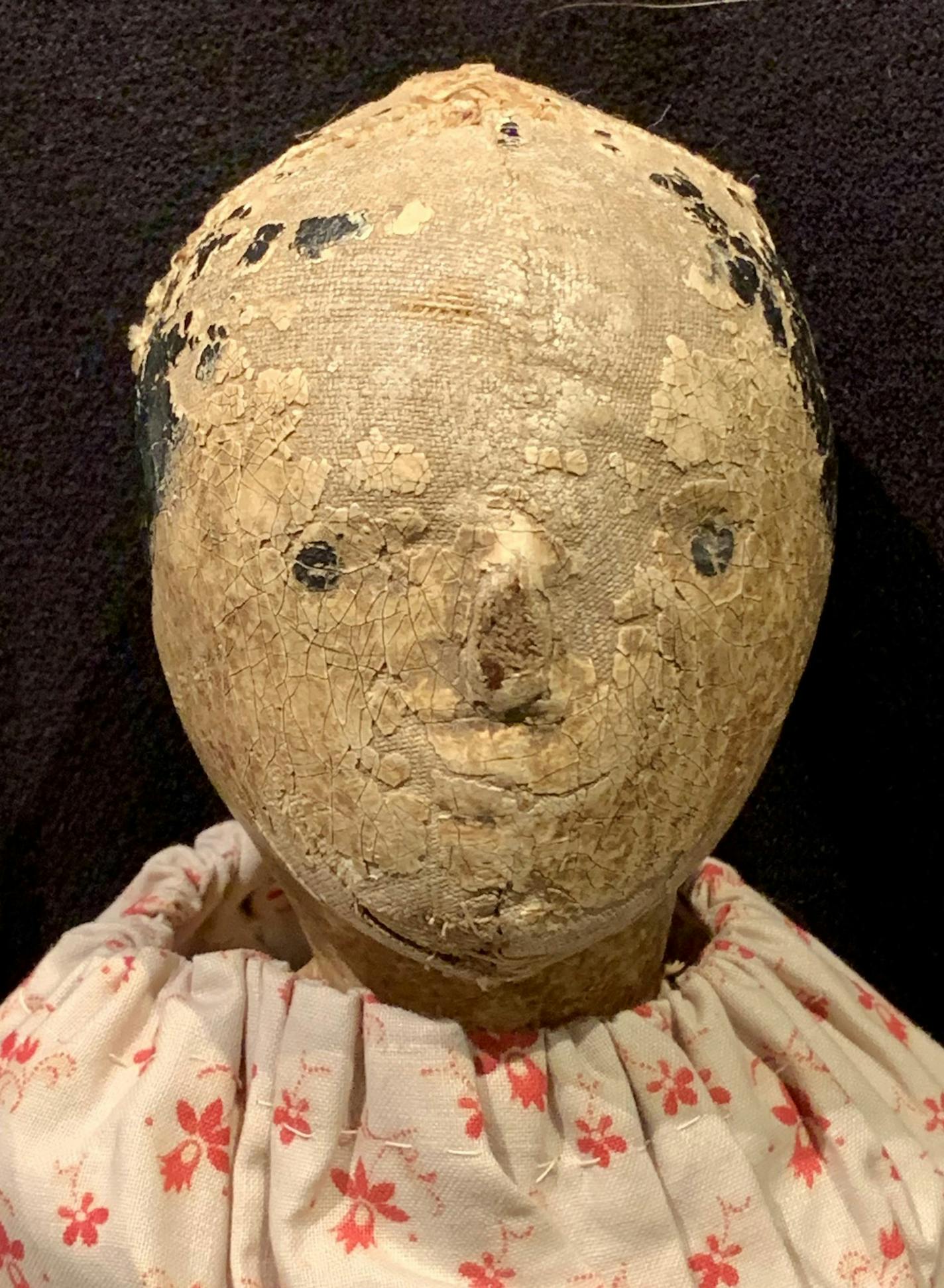 This doll once may have been beautiful, but age and use have mummified it.