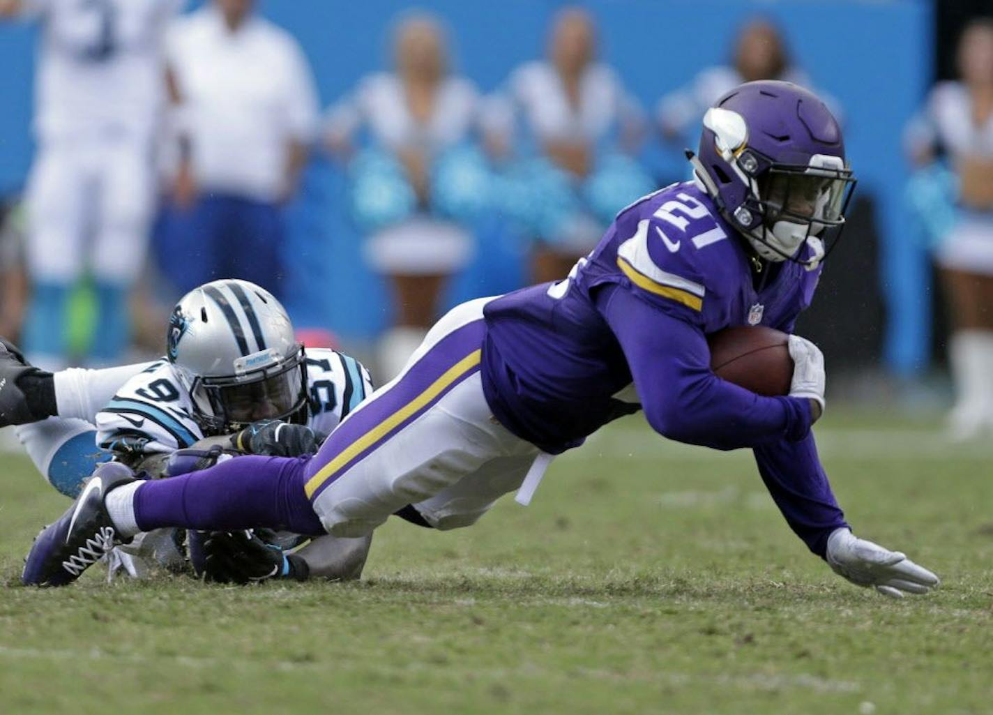 Minnesota Vikings' Jerick McKinnon (21) is tackled by Carolina Panthers' Mario Addison (97) in the second half of an NFL football game in Charlotte, N.C., Sunday, Sept. 25, 2016.