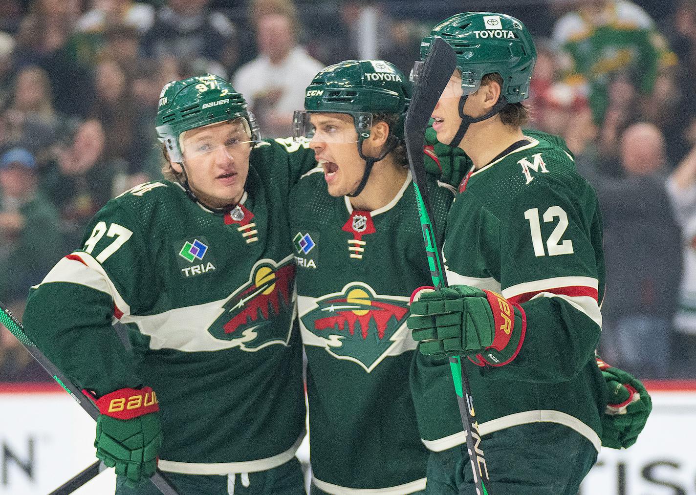 Minnesota Wild left wings Kirill Kaprizov (97) and Matt Boldy (12) celebrate with center Joel Eriksson Ek (14) after he scored a goal against the New Jersey Devils in the first period Saturday, Feb. 11, 2023 at Xcel Energy Arena in St. Paul, Minn. ]