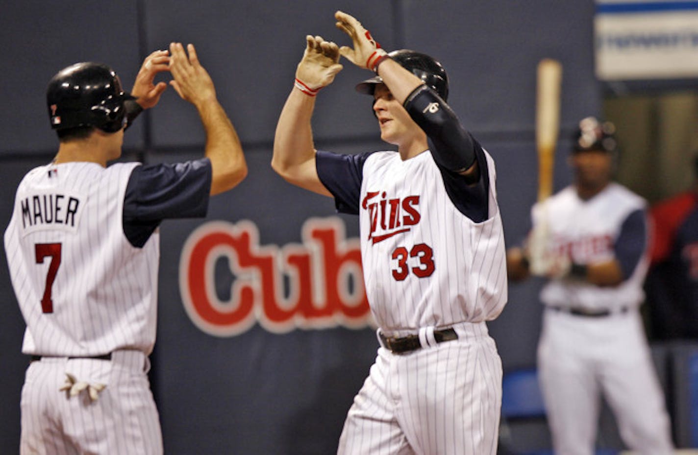 Minnesota Twins host the Washington Nationals
Twins first baseman Justin Morneau celebrates with catcher Joe Mauer at home plate after hitting a two-run homerun in the bottom of sixth inning Tuesday night against the Nationals.