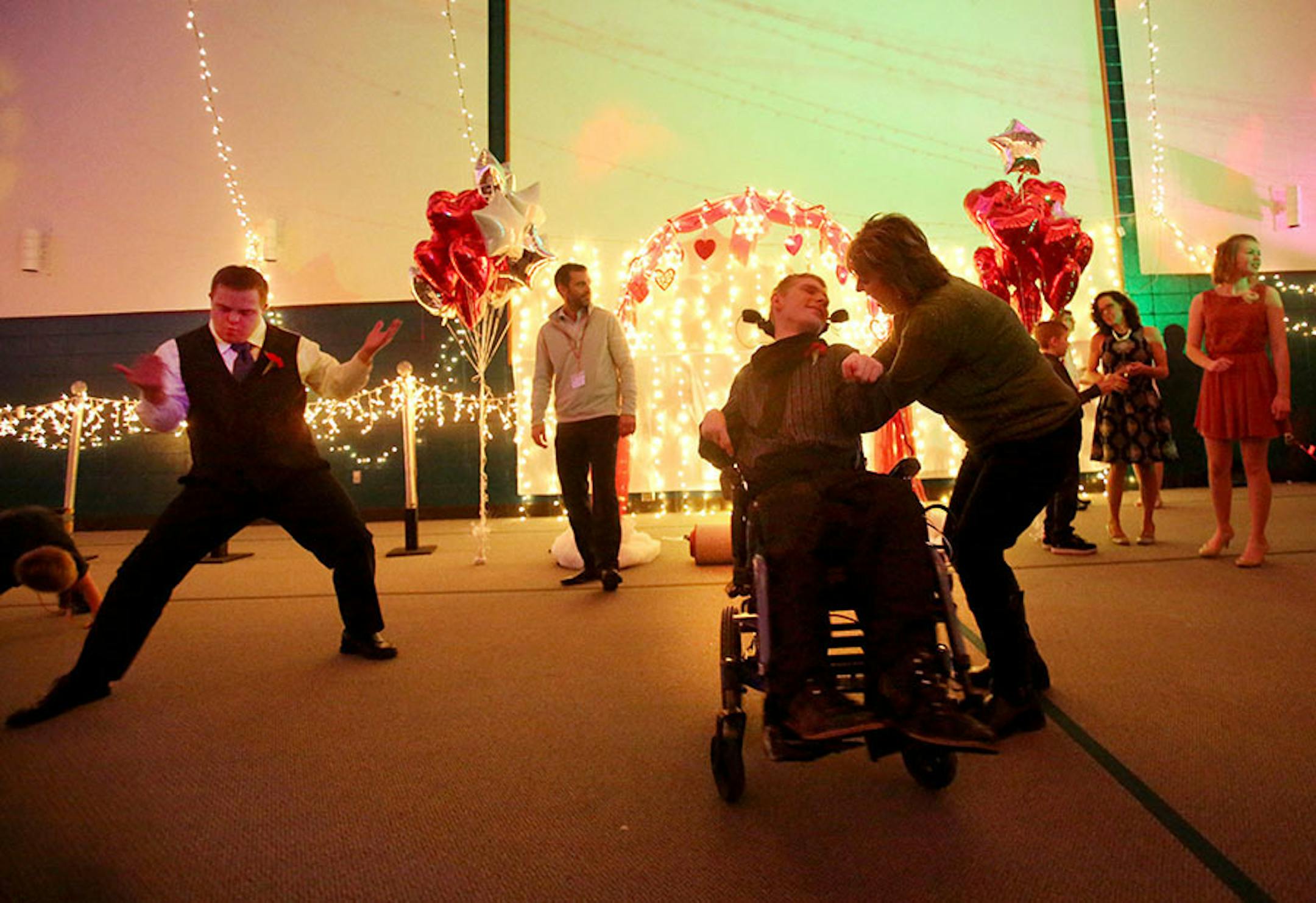 Matthew Larson of Savage gets a whirl in his wheelchair from his mom Lisa Larson while on the dance floor at the Snowflake Ball Saturday, Feb. 20, 2016, at Ridgewood Church in Minnetonka. Lisa Larson described the dance at Matthew's "last fling," before he has hip surgery. Matthew has cerebral palsey. Dancing to Matthew's left is Kyle Burtman.
