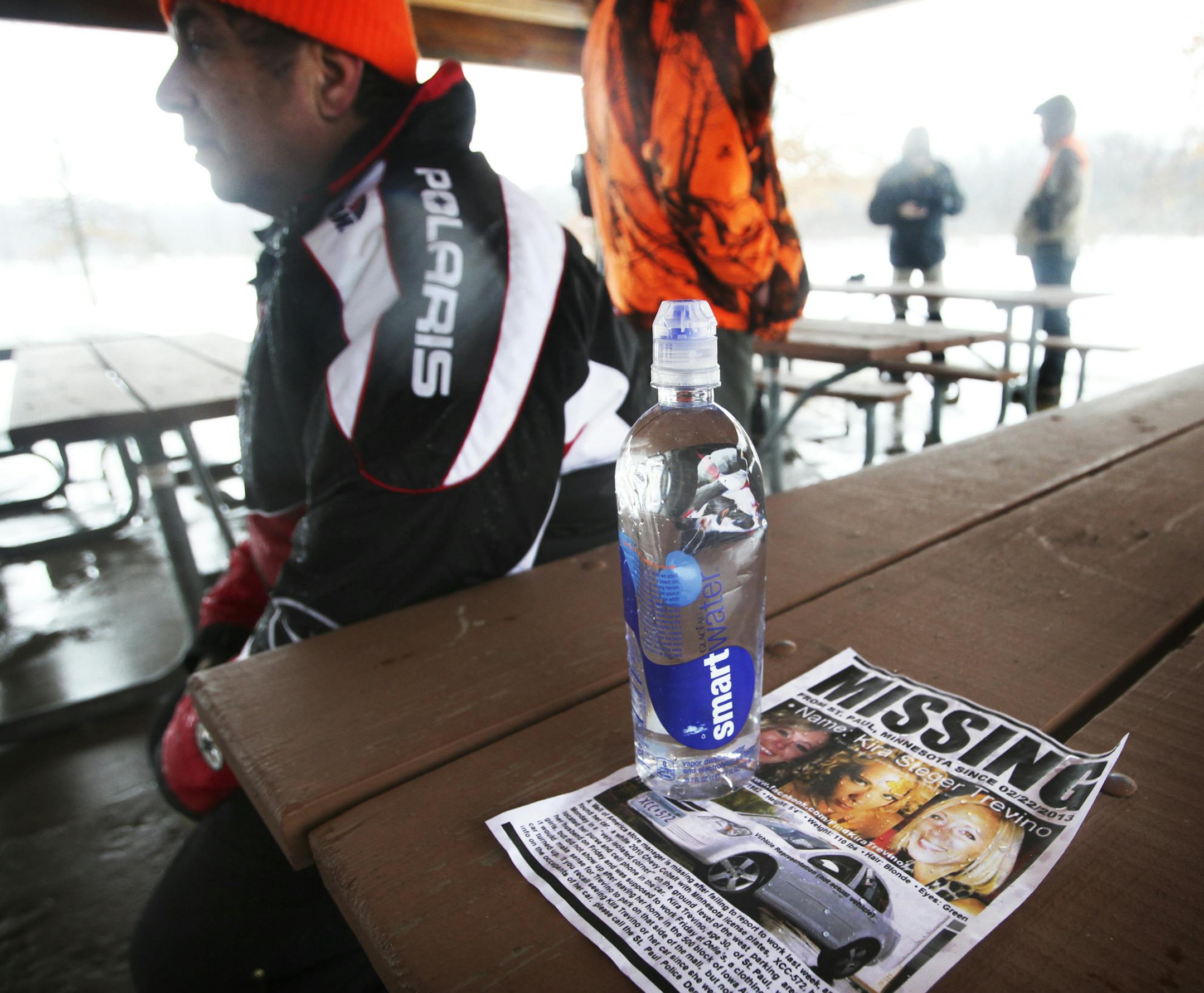 Raindrops soak a poster for missing St. Paul woman Kira Trevino on a picnic table in Spring Lake Reserve, along the Mississippi River Saturday, March 9, 2013 in Rosemount, MN, where a search for Trevino's body took place. Seated next to the poster was volunteer searcher Rick Kmett of Albertville, who gave a prayer prior to the start of the search.] (DAVID JOLES/STARTRIBUNE) djoles@startribune.com Volunteers searched the Spring Lake Reserve Saturday, March 9, 2013, in Rosemount, near the Mississi