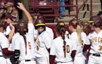 Gophers' first baseman Hope Brandner was congratulated by teammates after hitting a home run in April.