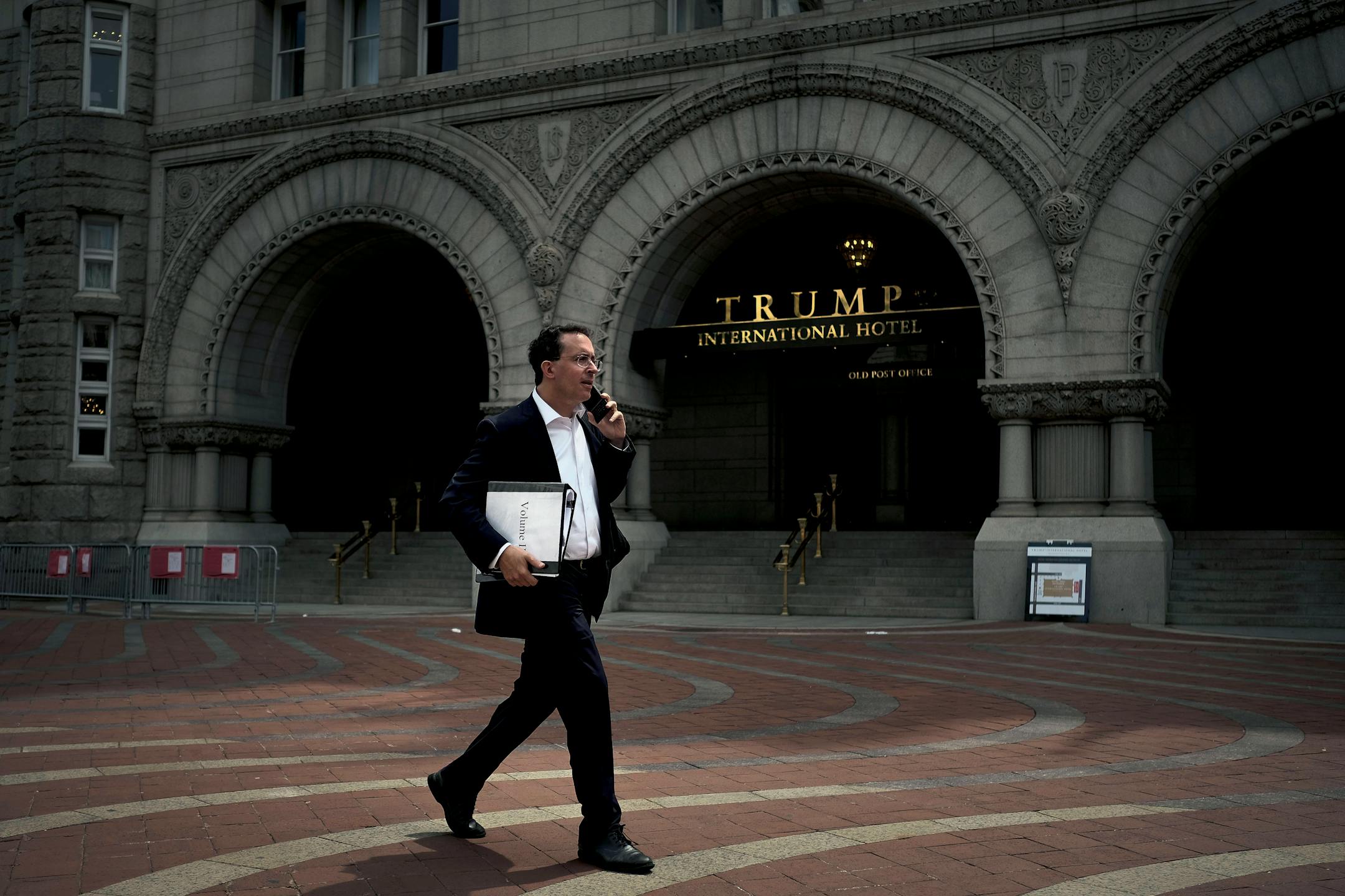 A man carried printed copies of a redacted version of the special counsel's report as he walked past the Trump International Hotel in Washington on Thursday.