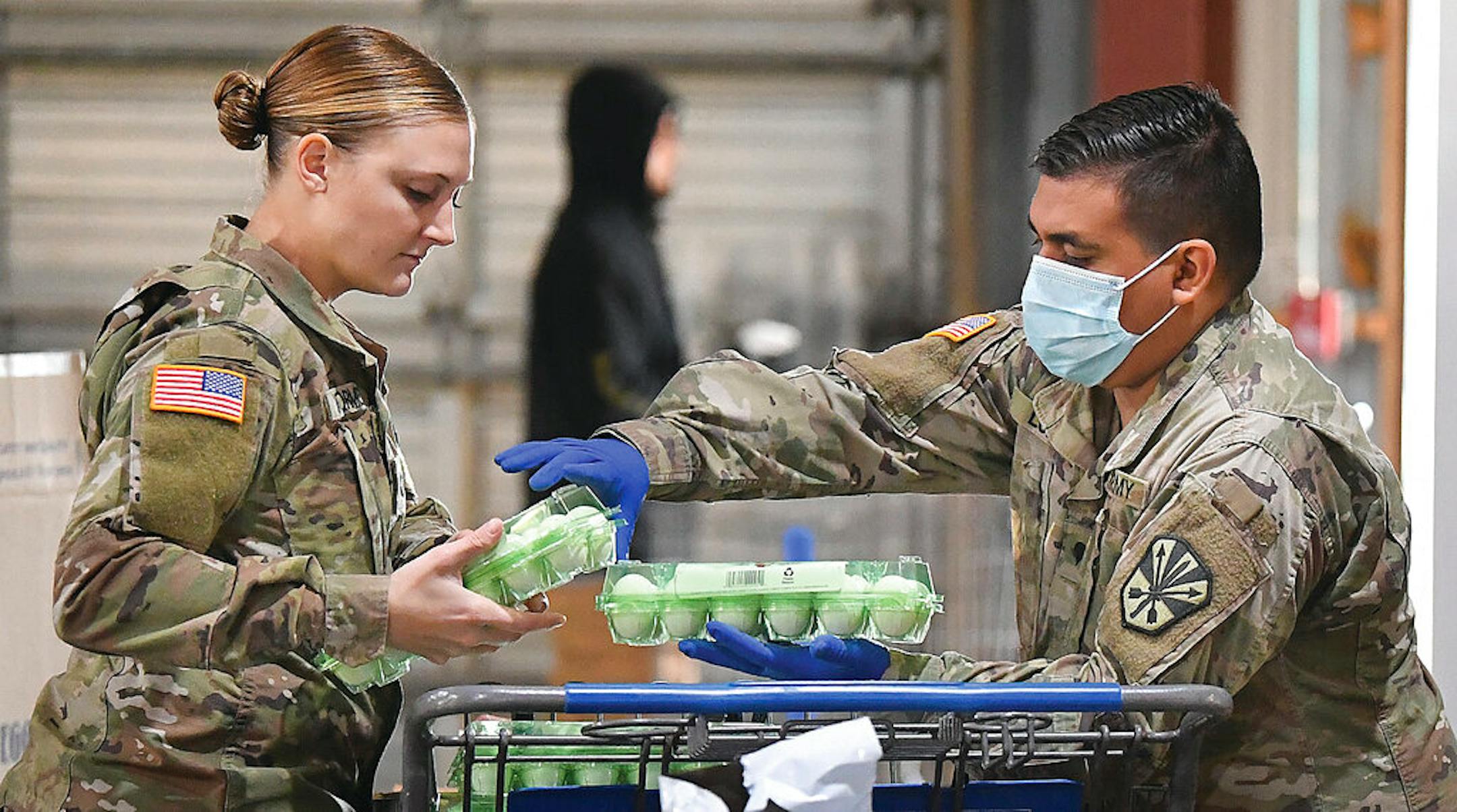 U.S. Army Arizona National Guard Spc. Jordyn VanWormer, left, and Spc. Angel Lopez load eggs into a shopping cart inside Yuma Community Food Bank, early Friday morning, Dec. 4, 2020, in Yuma, Aiz. It was the Guard's last day working at the Food Bank. Soldiers had been assisting with serving the needs of Yumans since April during the COVID-19 pandemic.