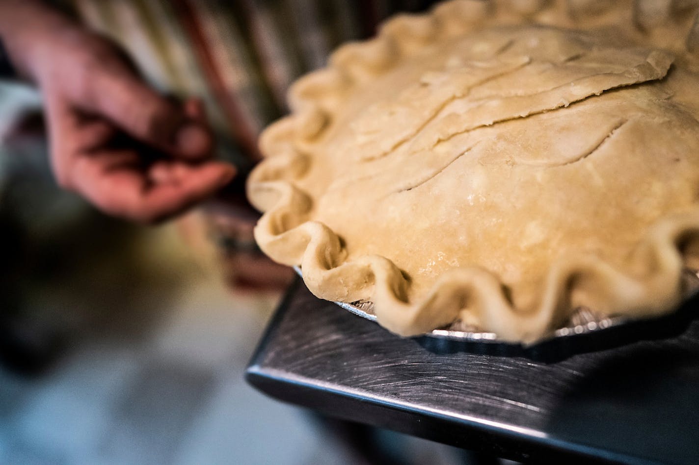 Credit: Courtney Perry Rachel Swan of Pie & Mighty in the process of crimping a crust