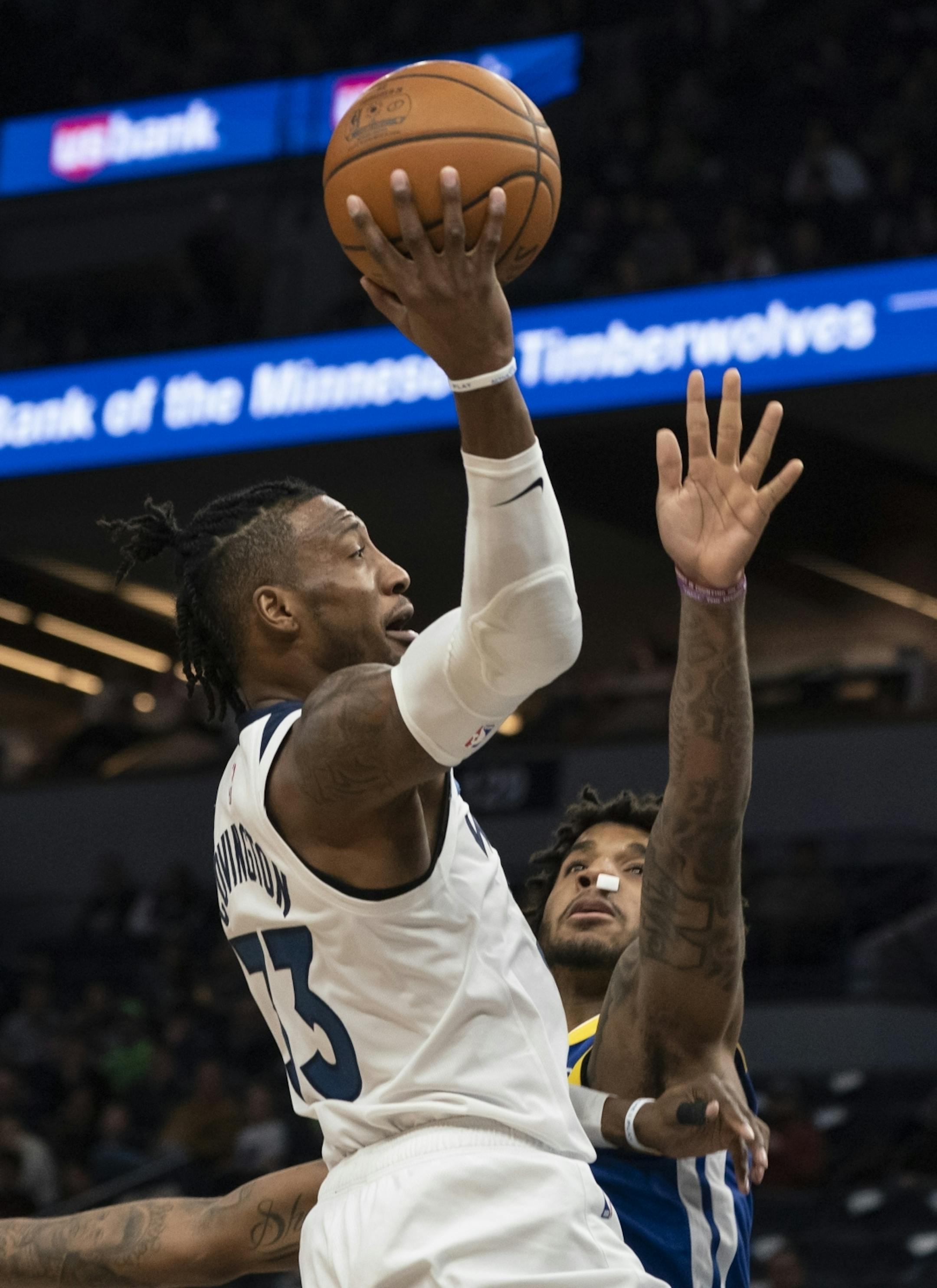 Minnesota Timberwolves forward Robert Covington (33) jumped for a shot against Golden State Warriors forward Marquese Chriss (32) in the first half.
