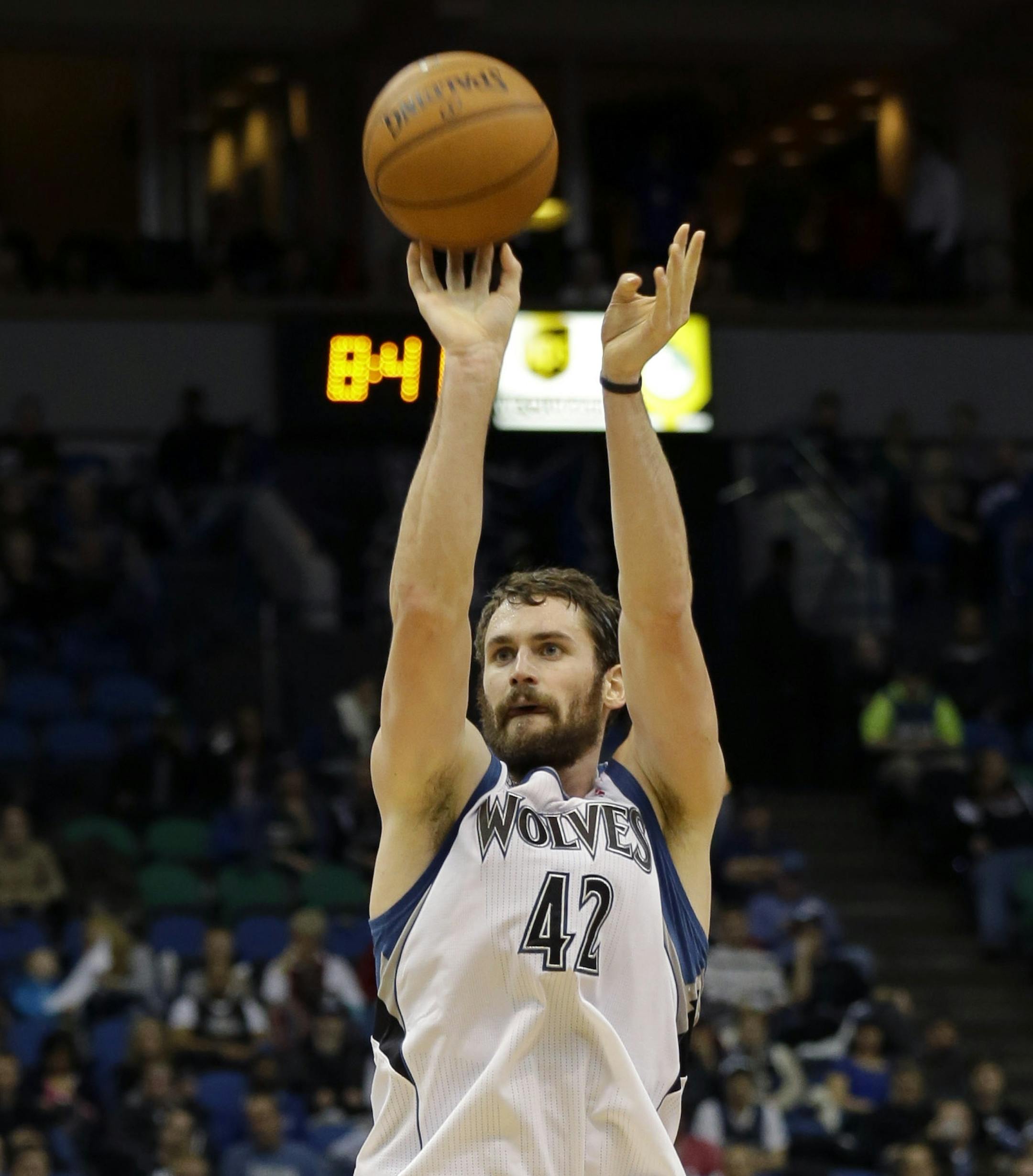 Minnesota Timberwolves forward Kevin Love (42) releases a 3-point shot over Portland Trail Blazers forward LaMarcus Aldridge (12) during the third quarter of an NBA basketball game in Minneapolis, Wednesday, Dec. 18, 2013. Love had 29 points as the Timberwolves won 120-109. (AP Photo/Ann Heisenfelt)