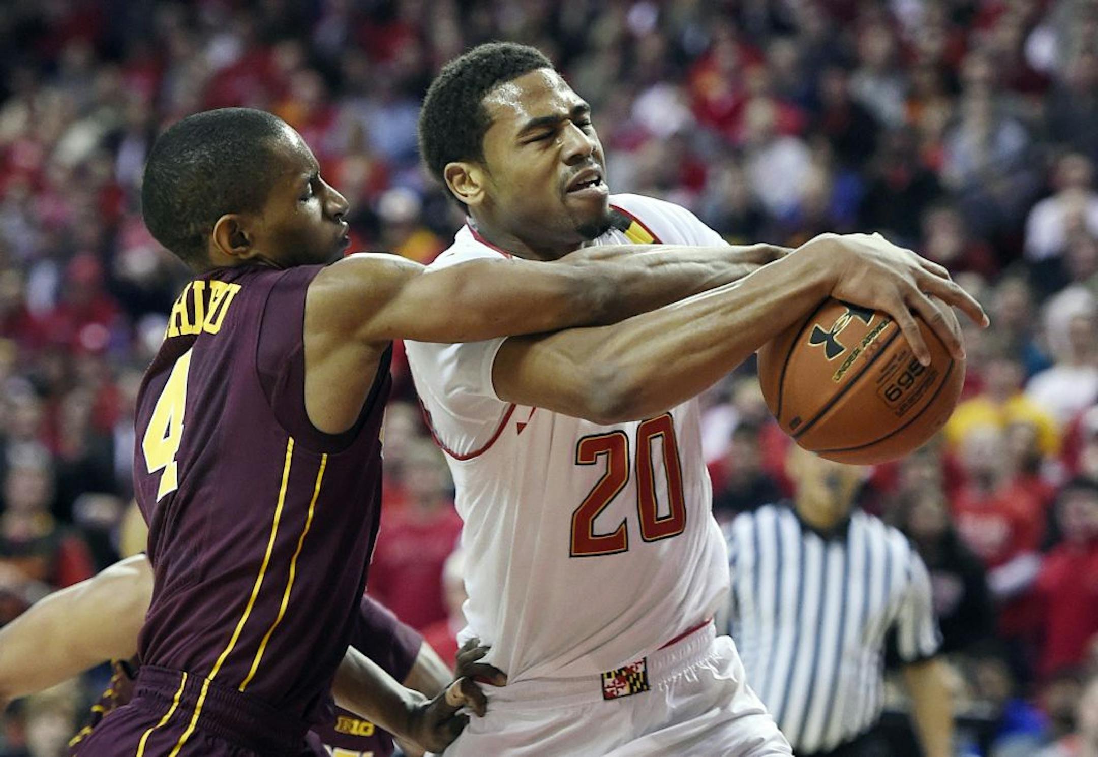 Maryland guard Richaud Pack, right, drives to the basket as Minnesota guard Deandre Mathieu defends during the first half of an NCAA college basketball game, Saturday, Jan. 3, 2015, in College Park, Md.