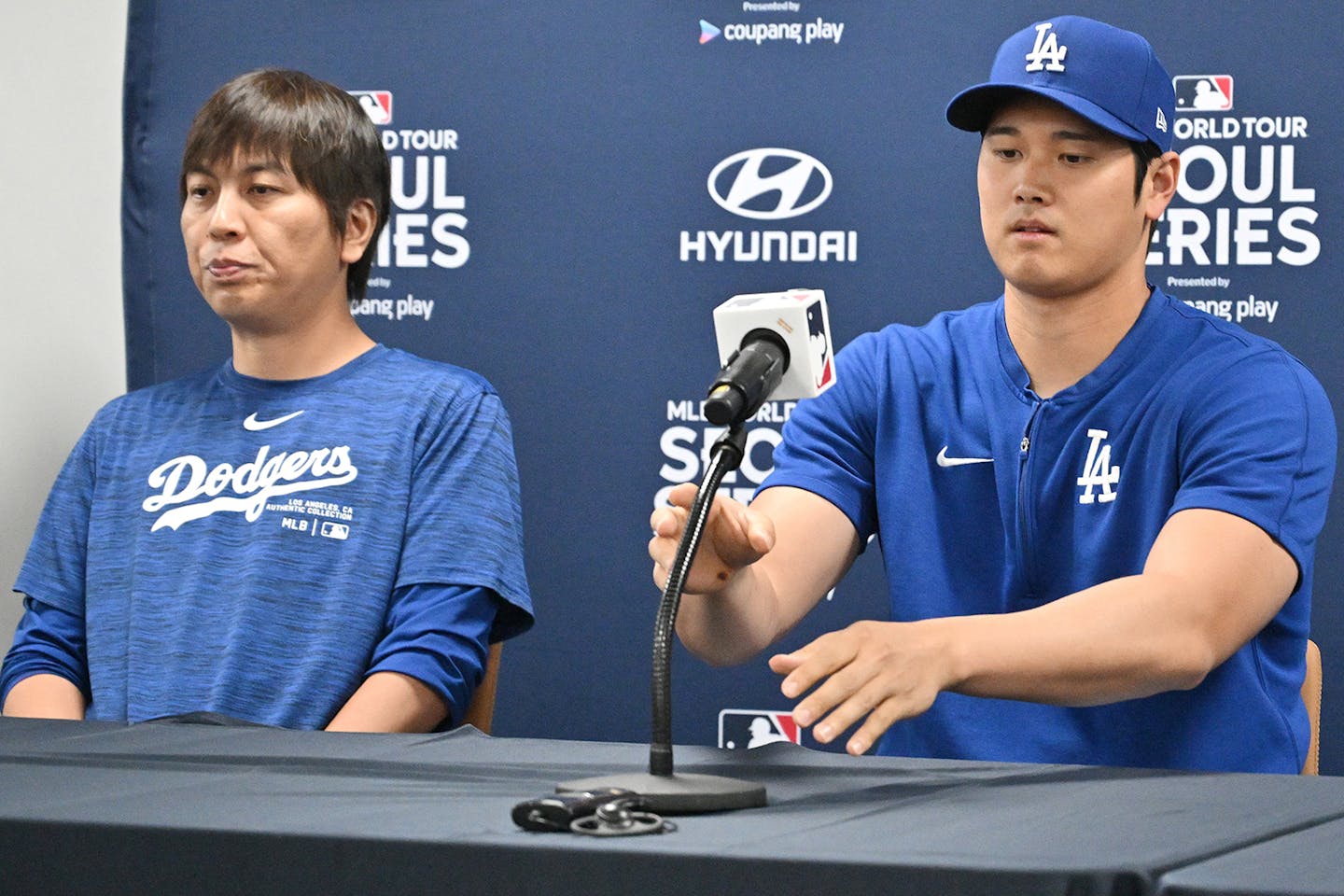 This picture taken on March 16, 2024, shows Los Angeles Dodgers' Shohei Ohtani (right) and his interpreter Ippei Mizuhara (left) attending a press con