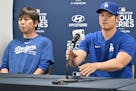 This picture taken on March 16, 2024, shows Los Angeles Dodgers' Shohei Ohtani (right) and his interpreter Ippei Mizuhara (left) attending a press con