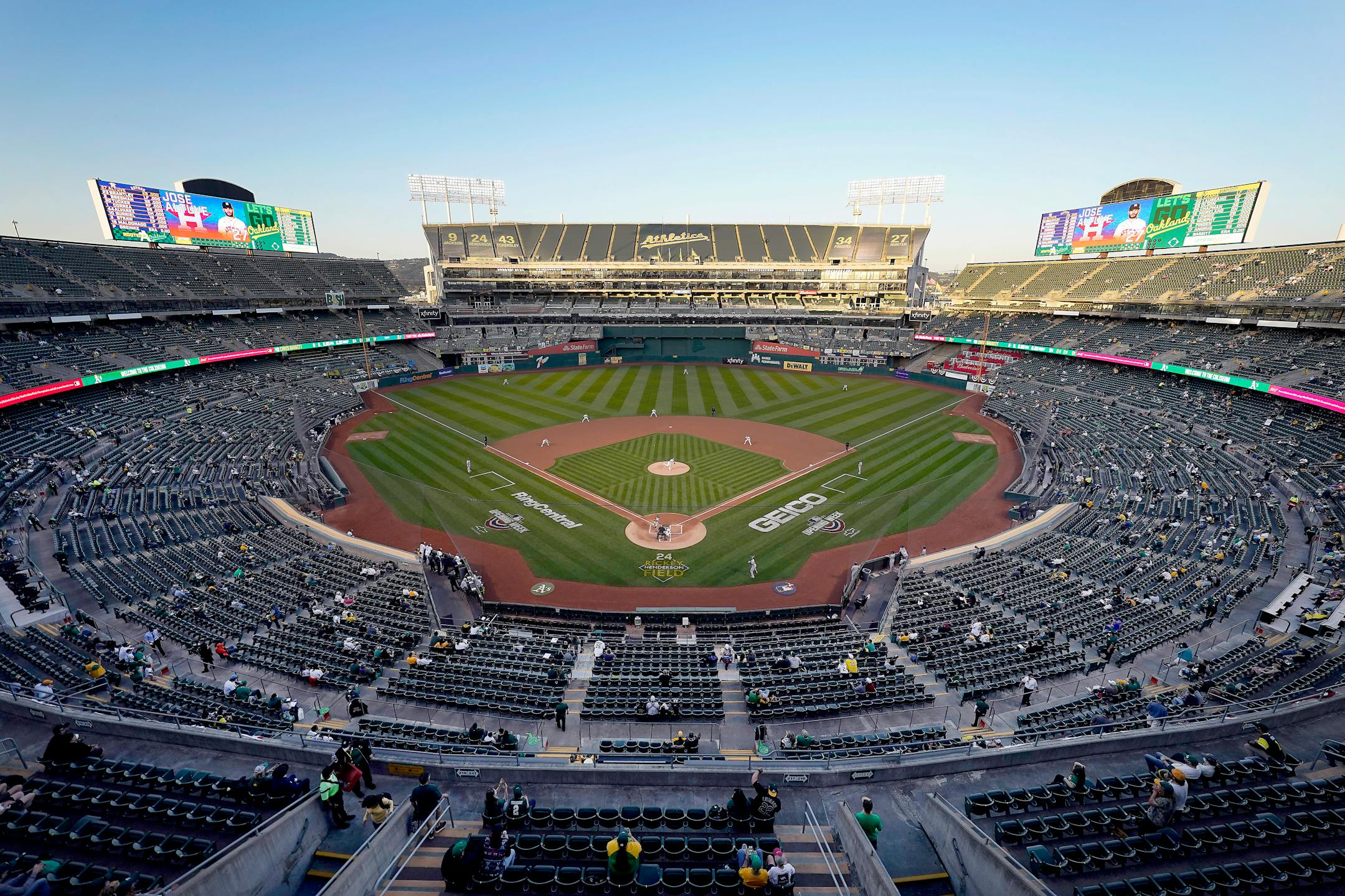 Oakland Athletics starting pitcher Chris Bassitt, center, works against Houston Astros' Jose Altuve during the first inning of a baseball game Thursday, April 1, 2021, Oakland, Calif. Fans at RingCentral Coliseum were back at the ballpark for the first time since the 2019 season, and were seated in separate "seating pods" under a reduced stadium capacity policy due to the COVID-19 pandemic. (AP Photo/Tony Avelar)