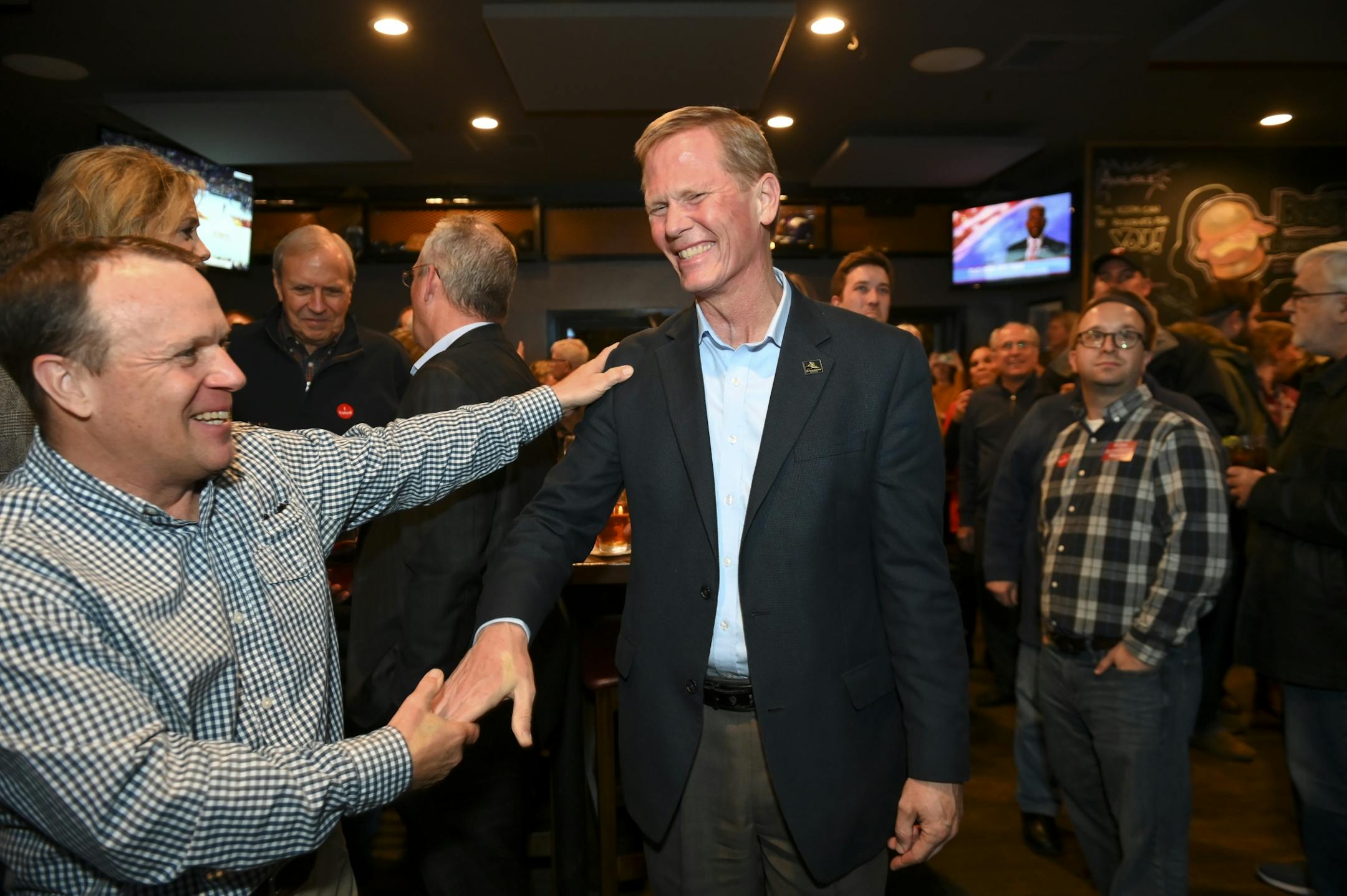 Paul Riester, left, a longtime friend from Minneapolis, shook hands with Bloomington Mayor-elect Tim Busse during Busse's election night watch party Tuesday night.