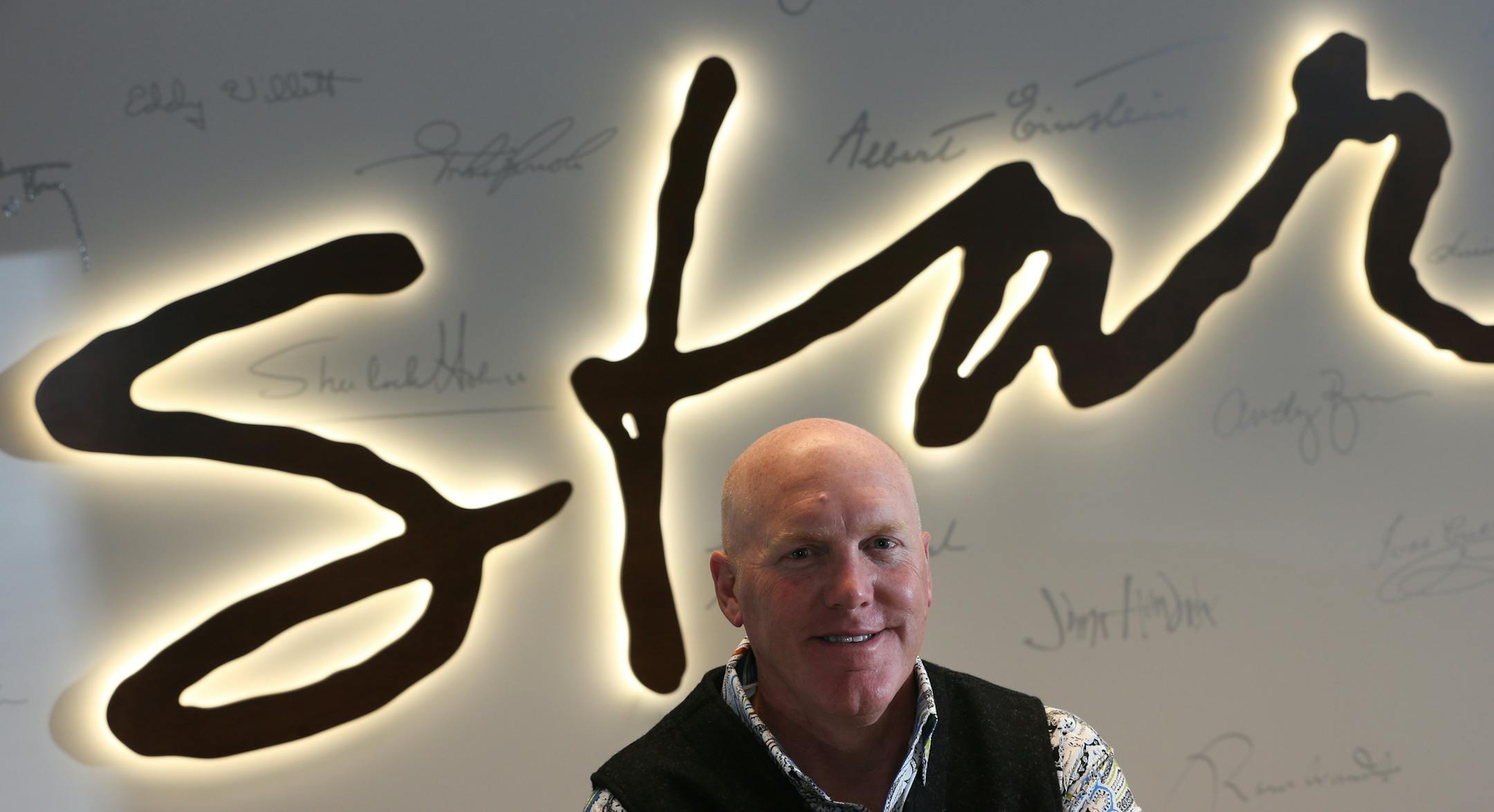 Star CEO Mark Johnson was photographed in his office on 10/22/13, infront of a neon logo . A nightmare deadline assignment -- converting a giant abandoned pier into a setting for a brand unveiling event where J.C. Penney hundreds of analysts, vendors and so forth, all in just four weeks -- is helping to launch a new business line for Star, a marketing, strategy, exhibits and trade show company marking 20 years in business this year. With corporate marketing departments downsized, Star has found