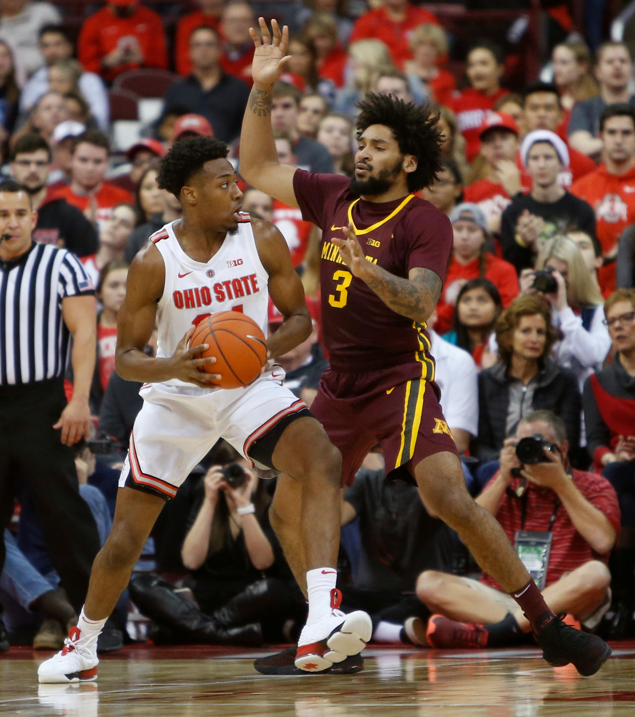 Ohio State's Andre Wesson, left, looks for an open pass as Minnesota's Jordan Murphy defends during the first half of an NCAA college basketball game Sunday, Dec. 2, 2018, in Columbus, Ohio. (AP Photo/Jay LaPrete)