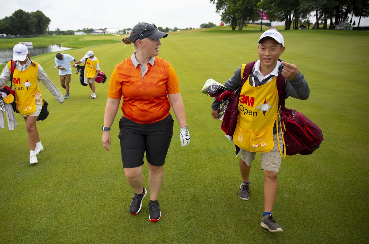 Nikki Jung (left) talked with her caddy, Jacob Roy, about the recently renovated 18th hole during a Pro-Am round on Monday. ALEX KORMANN &#xa5; alex.kormann@startribune.com Caddie U is a local non-profit that trains and places primarily teenage caddies for work at Twin Cities golf clubs. The program is supported by PGA Tour veteran Tim Herron. Jacob Roy had to work two jobs to support himself the last few years but through caddying and Caddie U, was able to pull himself up and receive a partial