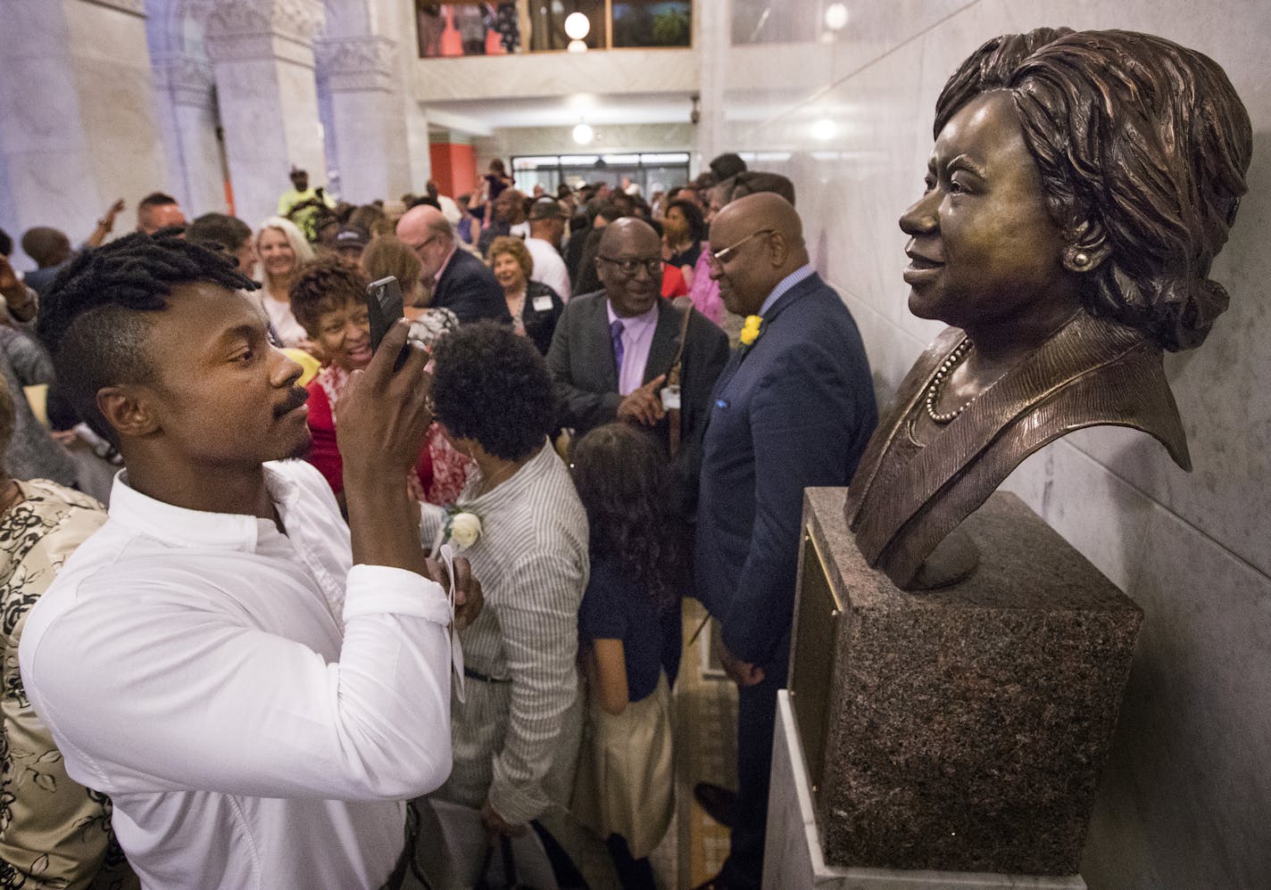 Coleman Belton the son of Sharon Sayles Belton took a photo of his mother's newly unveiled Bronze Tribute at Minneapolis City Hall. The Sharon Sayles Belton Bronze Tribute, honoring her achievements during her mayoral terms from 1994 to 2001, and in recognition of her being the first African-American and first woman mayor in the city. ] CARLOS GONZALEZ &#xef; cgonzalez@startribune.com - May 16, 2017, Minneapolis, MN, City Hall, Unveiling of the Sharon Sayles Belton Bronze Tribute, honoring her a