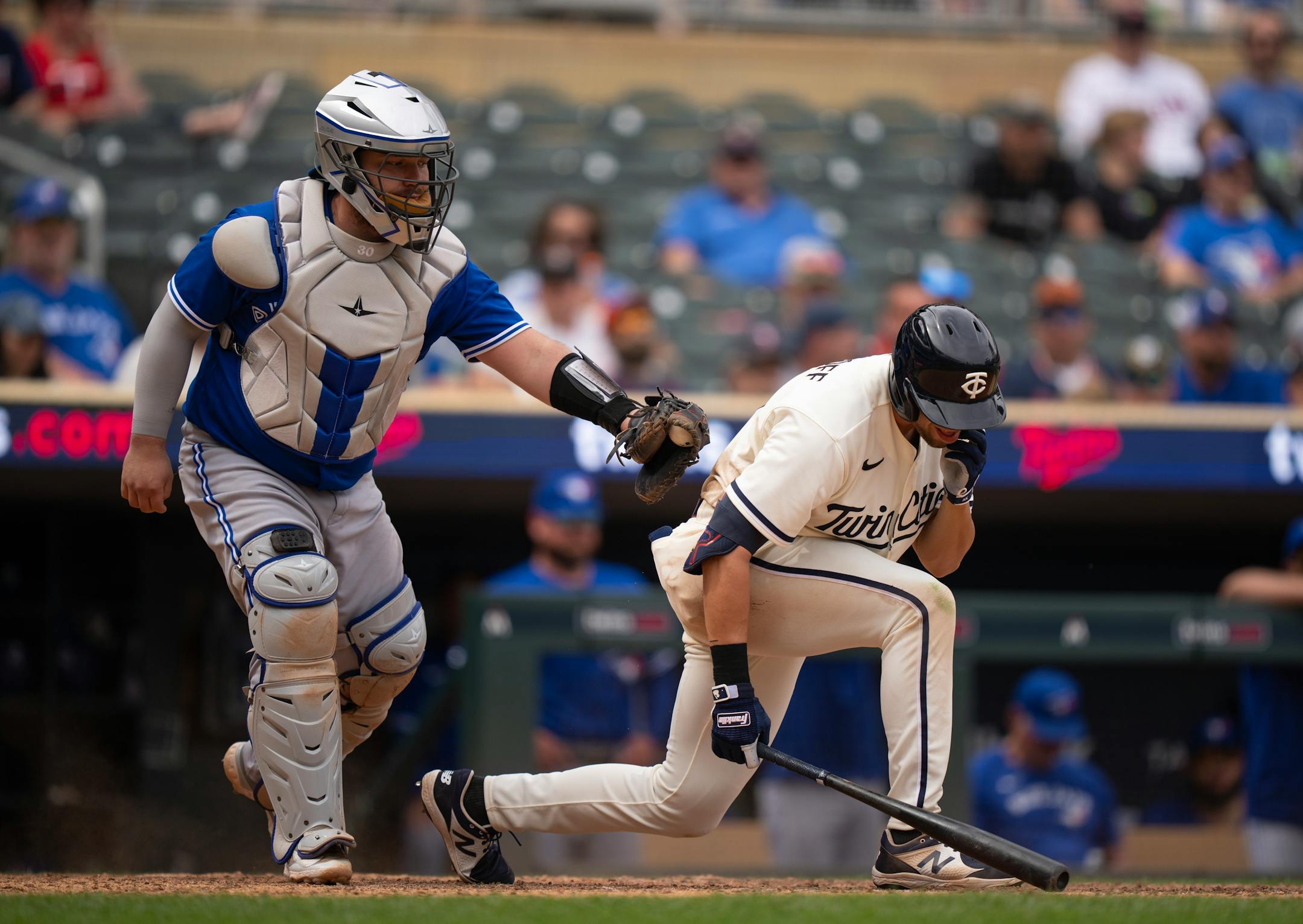 Toronto Blue Jays catcher Alejandro Kirk reached to tag out Minnesota Twins left fielder Alex Kirilloff (19) after he struck out swinging in the ninth inning.