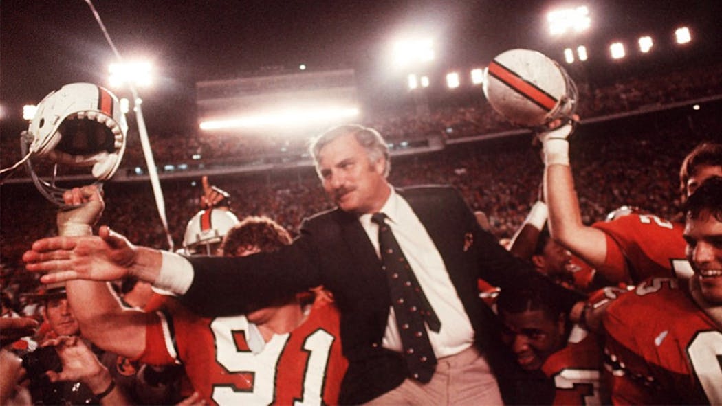 Miami coach Howard Schnellenberger was mobbed by players after defeating Nebraska in the Orange Bowl.