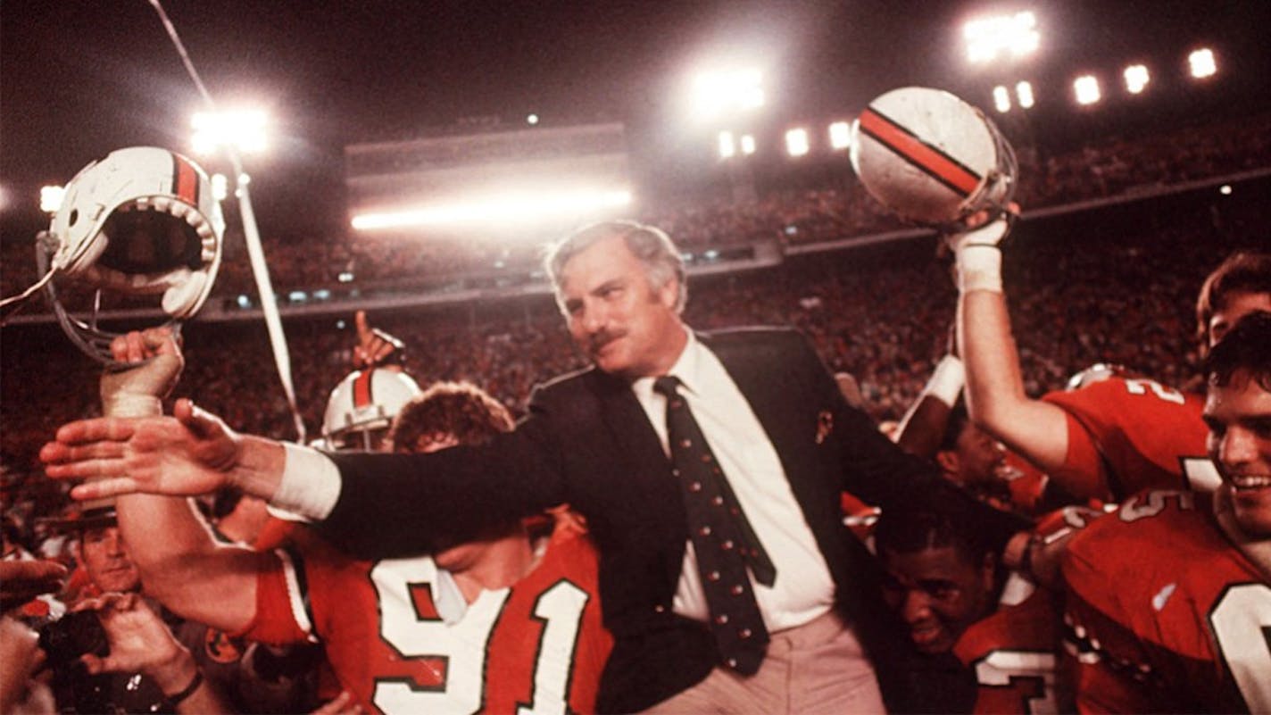 Miami coach Howard Schnellenberger was mobbed by players after defeating Nebraska in the Orange Bowl.