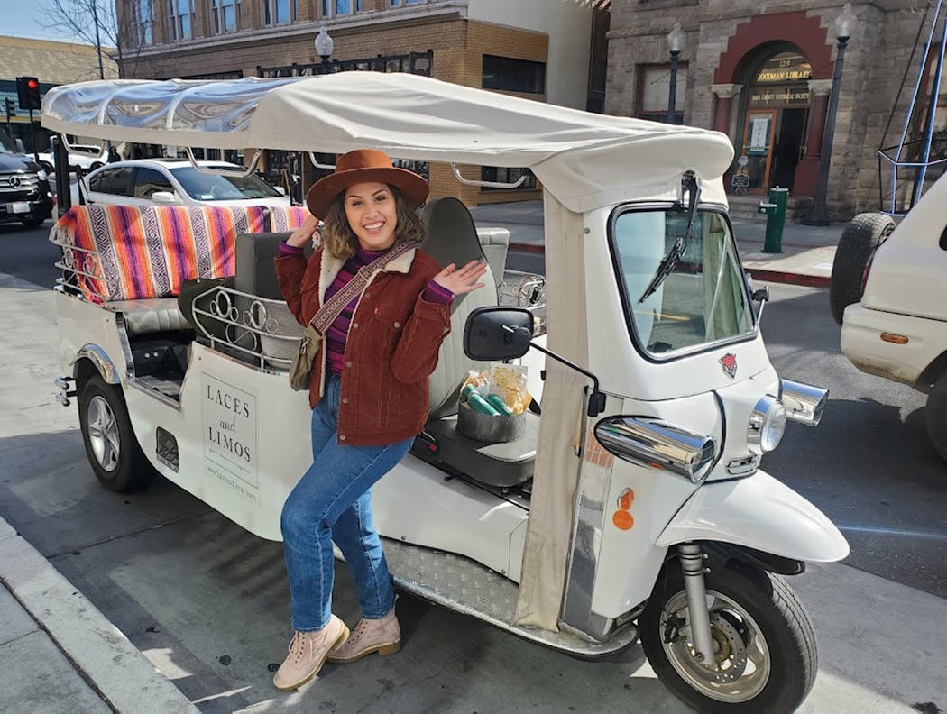 Millie Manaoat drives an electric tuk-tuk for Laces and Limos, which offers winery tours out of downtown Napa. 