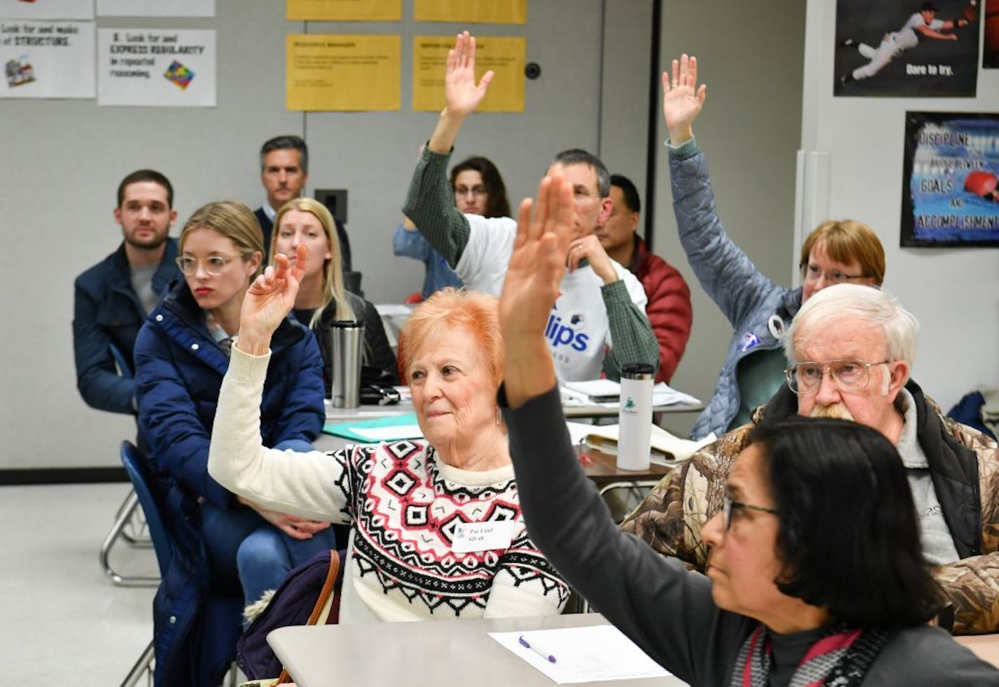 Stefan Peterson asked a DFL precinct caucus meeting at Eden Prairie High School for a show of hands Tuesday night on who would be willing to serve as delegates to the next party convention.