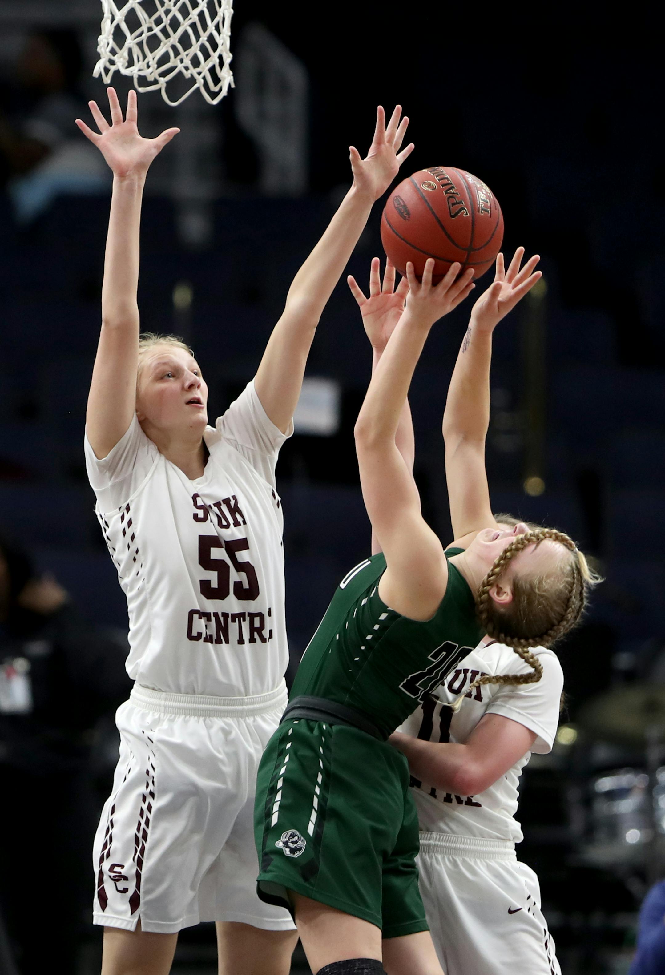 Roseau guard Katie Borowicz (20) is blinded by her own braids while putting up a shot against Sauk Centre's Kenzie Schmiesing (11) and Michaela Dammann (55) during the first half of the 2A girls' basketball state championships Saturday, March 17, 2018, at Target Center in Minneapolis, MN.] DAVID JOLES ï david.joles@startribune.com Lyle-Pacelli and Sleepy Eye 1A girls' basketball state championships