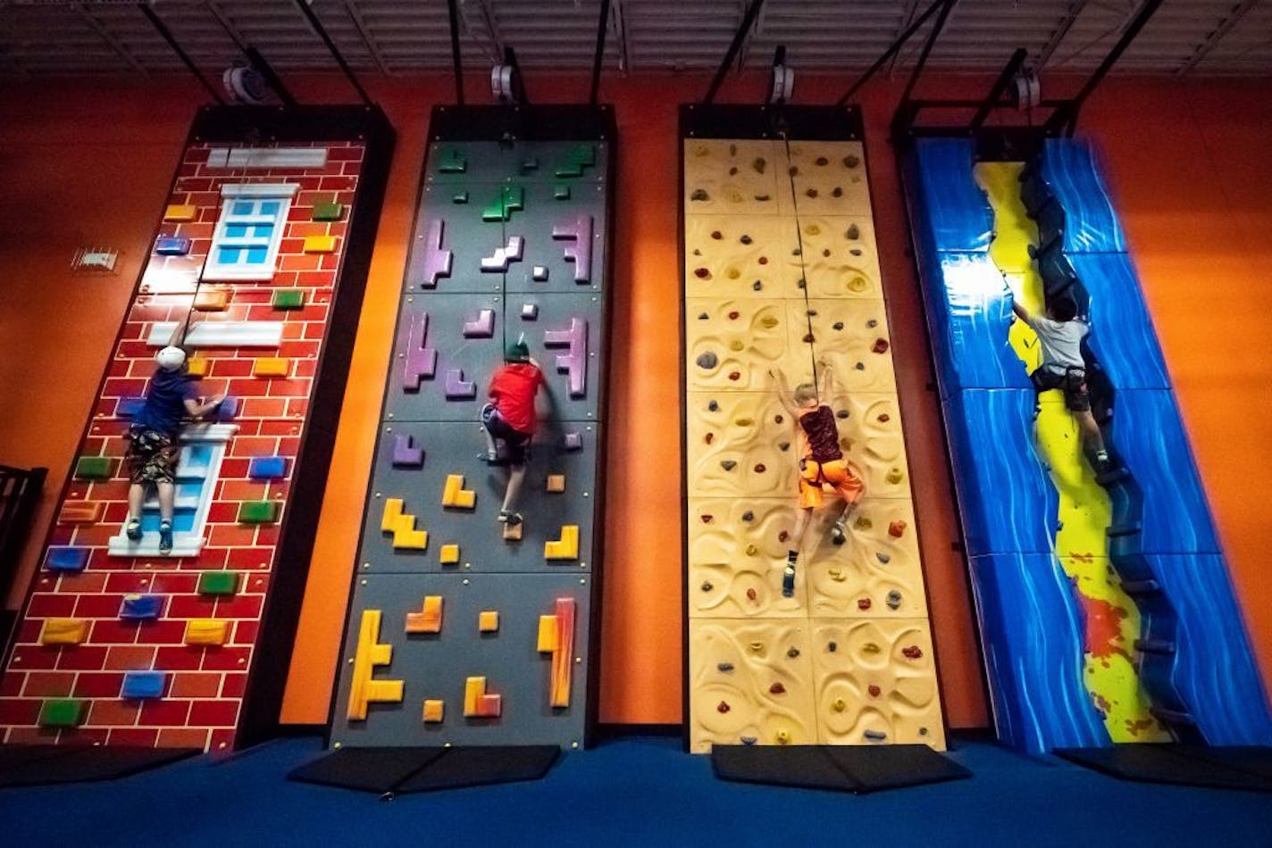 Christopher Fortin, 13, in the red shirt hit the climbing wall with his friends. This space that was once used as a Sports Authority store in Coon Rapids is now Urban Air Adventure Park where Christopher Fortin, 13 and his brother Ethan, 10 had their birthday party.