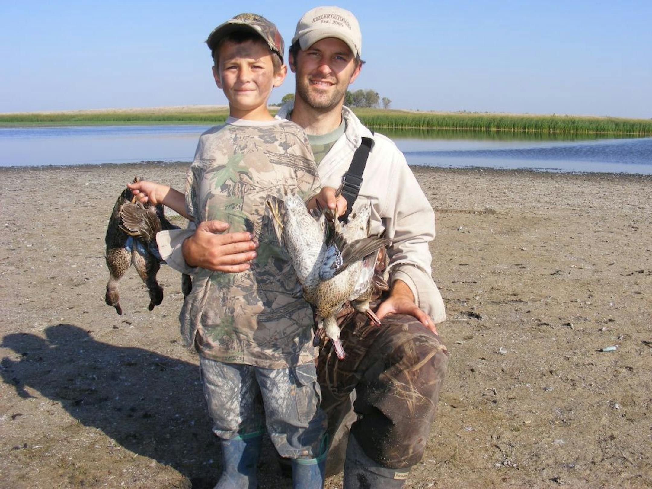 Matt Keller and his son Indiana with a harvest of waterfowl.