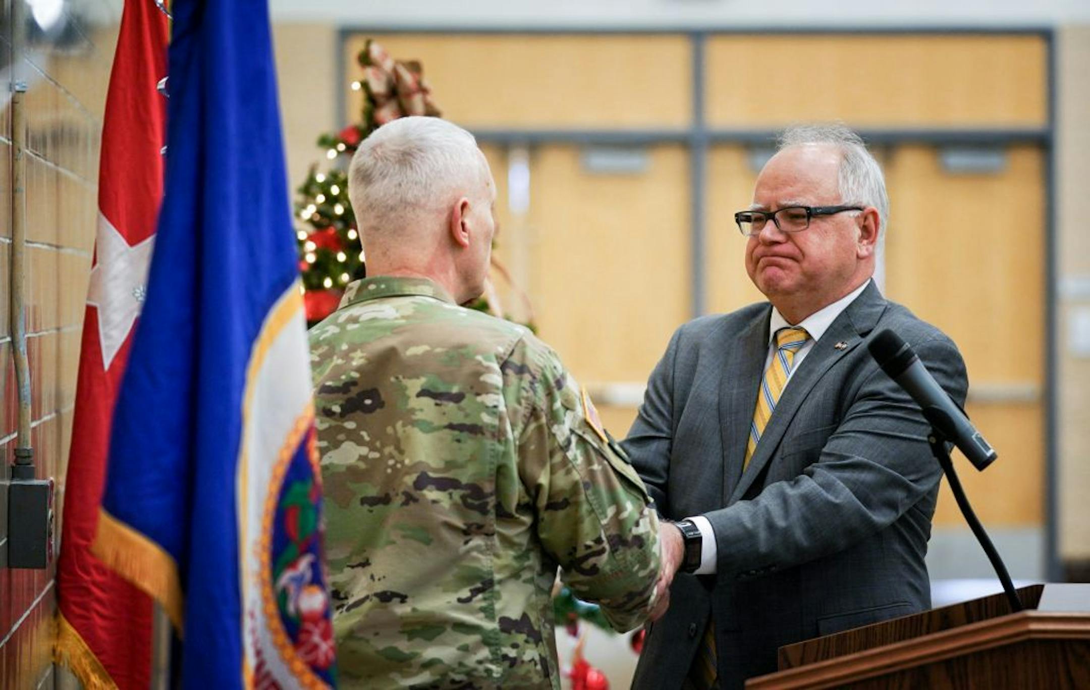 Minnesota Governor Tim Walz stopped by the Minnesota National Guard holiday gathering at the joint force headquarters where he greeted guard members. He thanked Adjutant General Jon Jensen for his introduction.