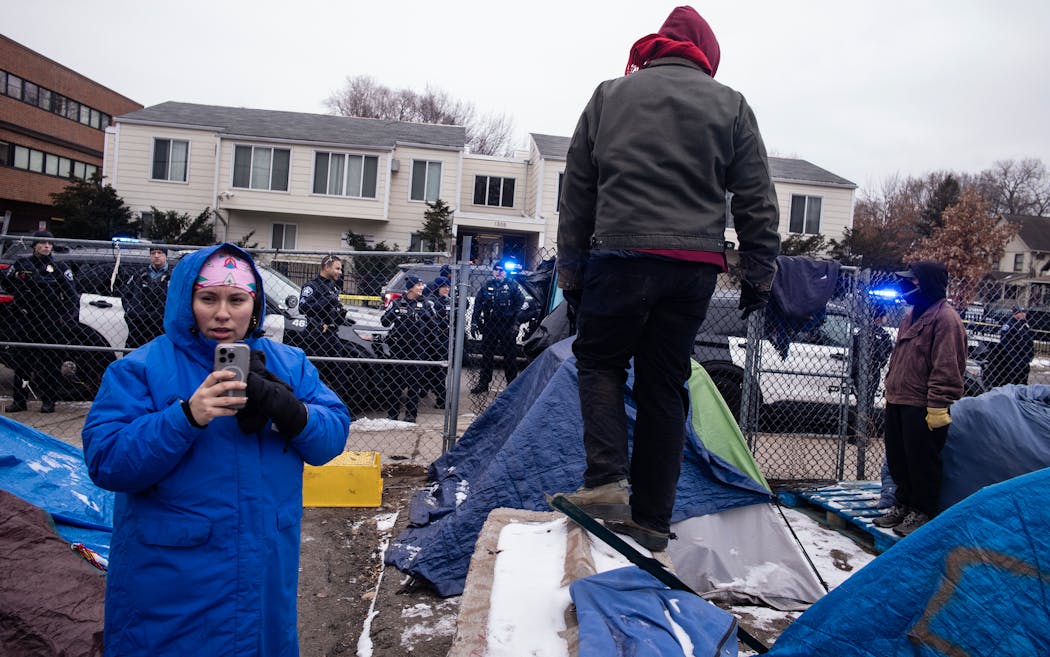 Police arrived ahead of the shutdown of Camp Nenookaasi in Minneapolis on Thursday. The city of Minneapolis planned to clear out the large homeless encampment over public safety and health concerns.