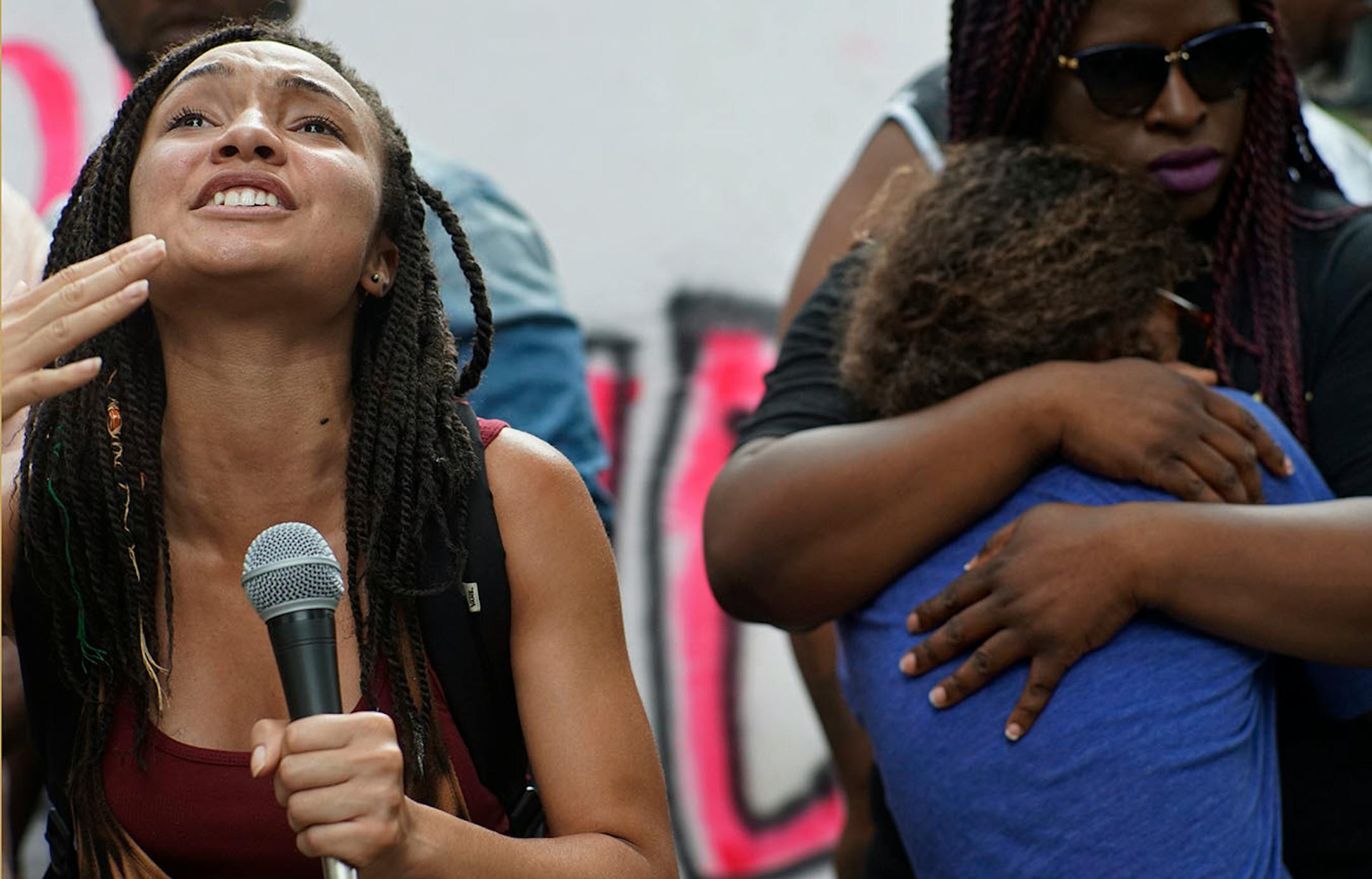 Nadia Poindexter prayed for the shooting victim as Minneapolis NAACP President Nekima Levy-Pound hugged her cousin Annah Daniels.
