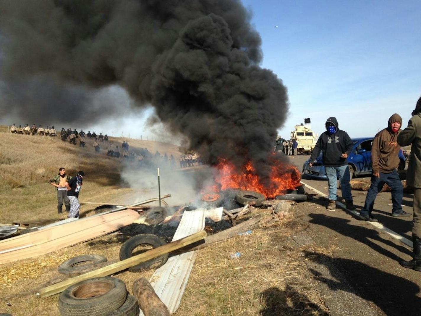 Dakota Access oil pipeline protesters burned debris as officers closed in to force them from a camp on private land in the path of pipeline construction on Thursday near Cannon Ball, N.D. Soldiers and law enforcement officers dressed in riot gear began arresting protesters who had set up a camp on private land to block construction of the Dakota Access oil pipeline.