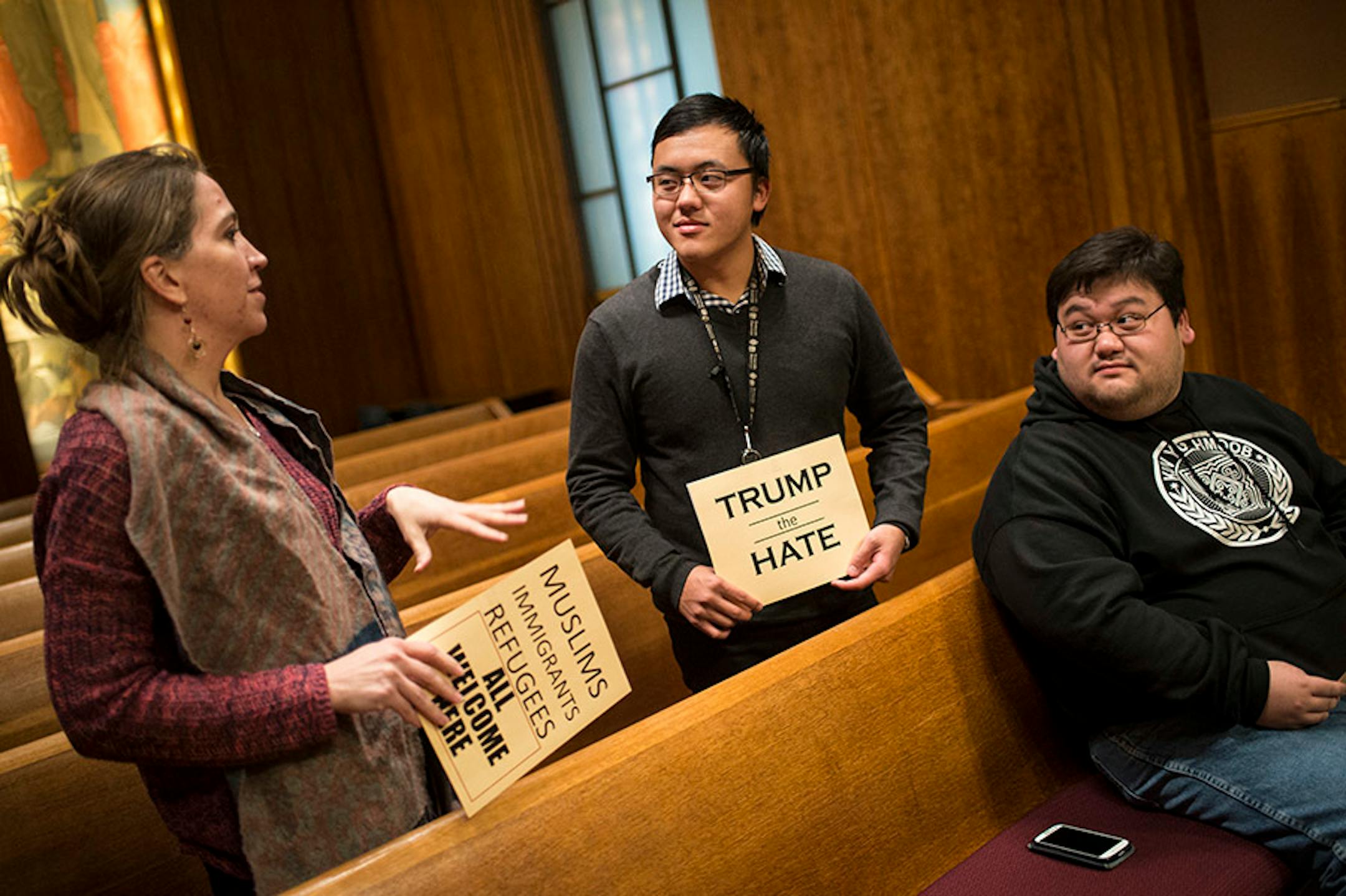 From left, Sarah Lechowich, of St. Paul, SuChann Yang, of St. Paul, and Chris Xiong, of Brooklyn Park, came out to voice their support for a city council resolution condemning Republican presidential candidate Donald Trump for anti-Muslim, anti-refugee and anti-immigrant speech Wednesday night.