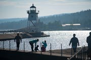 Visitors in front of the Grand Marais Lighthouse.