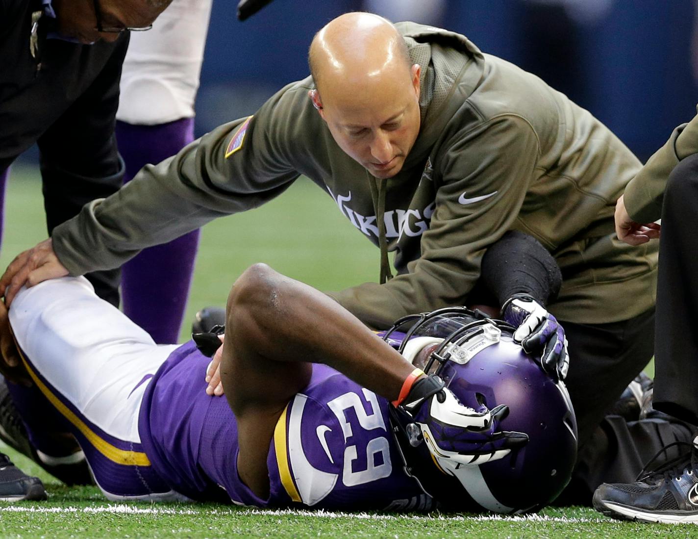 In this Nov. 3, 2013, file photo, Minnesota Vikings cornerback Xavier Rhodes (29) is attended to by head trainer Eric Sugarman during the second half of an NFL football game against the Dallas Cowboys in Arlington, Texas. Documents unsealed in a lawsuit by 1,800 former NFL players provide a behind-the-scenes glimpse at how team and league medical personnel distributed powerful painkillers to players. According to a Jan. 17, 2008 e-mail from Sugarman to team doctors and medical personnel, that wa