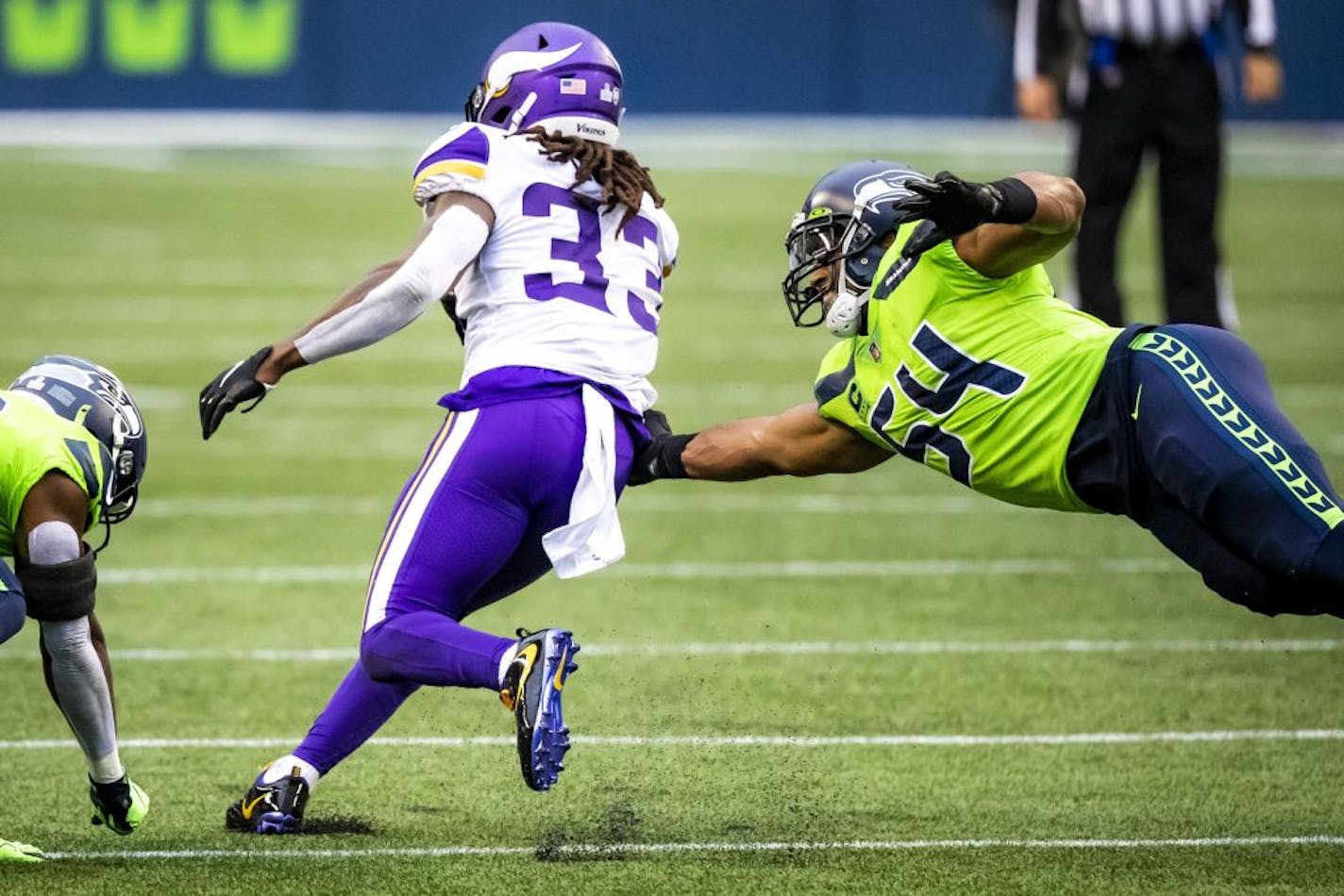 Vikings running back Dalvin Cook gets by Seahawks middle linebacker Bobby Wagner and Seahawks safety Ugo Amadi in the first half as the Seattle Seahawks take on the Minnesota Vikings at CenturyLink Field in Seattle Sunday October 11, 2020.