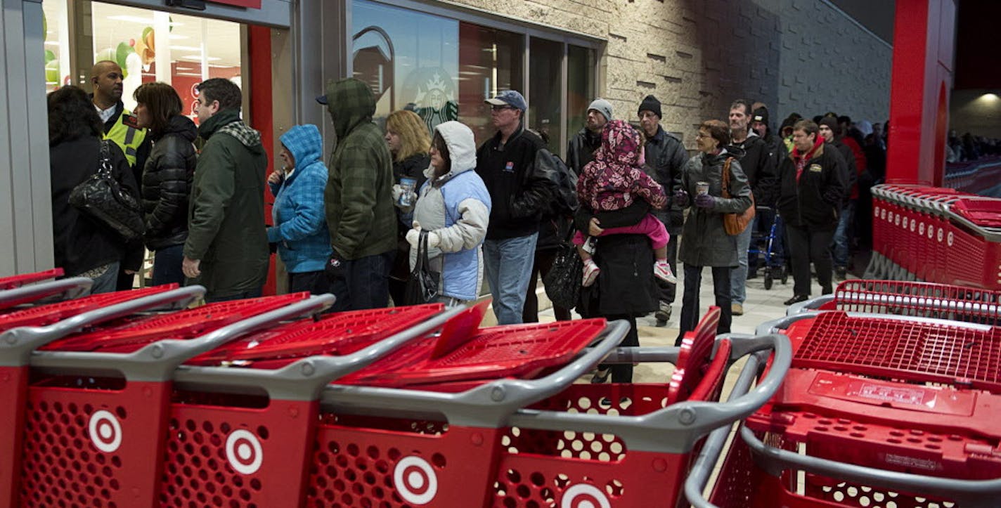 Shoppers enter a Target store in Dartmouth, Nova Scotia, on Friday, Nov. 29, 2013. Black Friday, thought to be the most important shopping day of the year in the United States, is having an impact on Canadian sales as retailers work to keep consumers home, north of the border. (AP Photo/The Canadian Press, Andrew Vaughan)