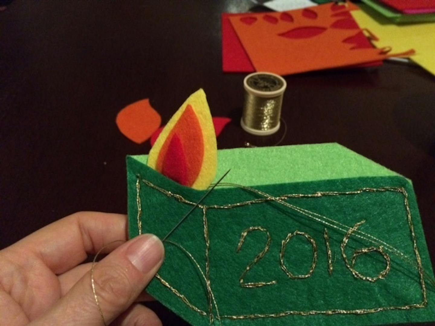 Part of step-by-step instructions for crafting a felt dumpster fire holiday ornament.