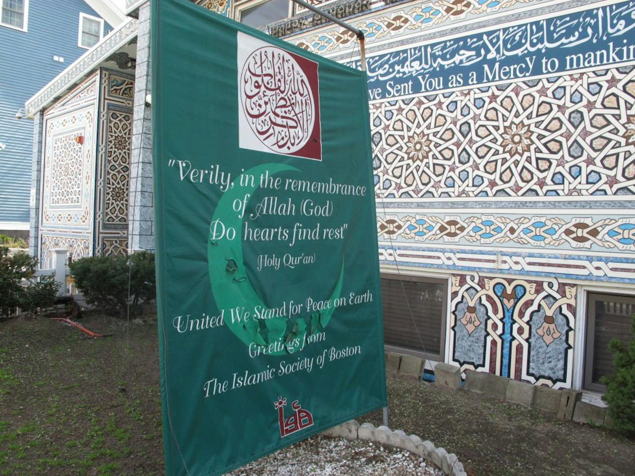 A banner reading "United We Stand For Peace on Earth" stands outside the Islamic Society of Boston mosque in Cambridge, Mass., on April 19, 2013