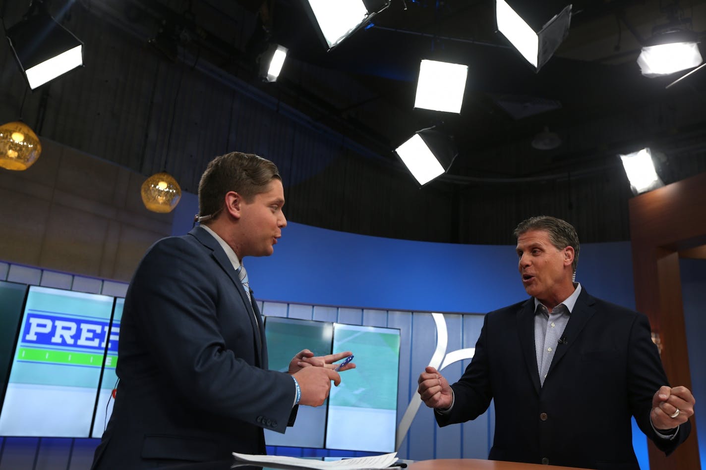 Randy Shaver, right, talks with his son, Ryan, before they go on air during the Prep Sports Extra show at the KARE 11 studio in Minneapolis on Friday, Nov. 2, 2018.