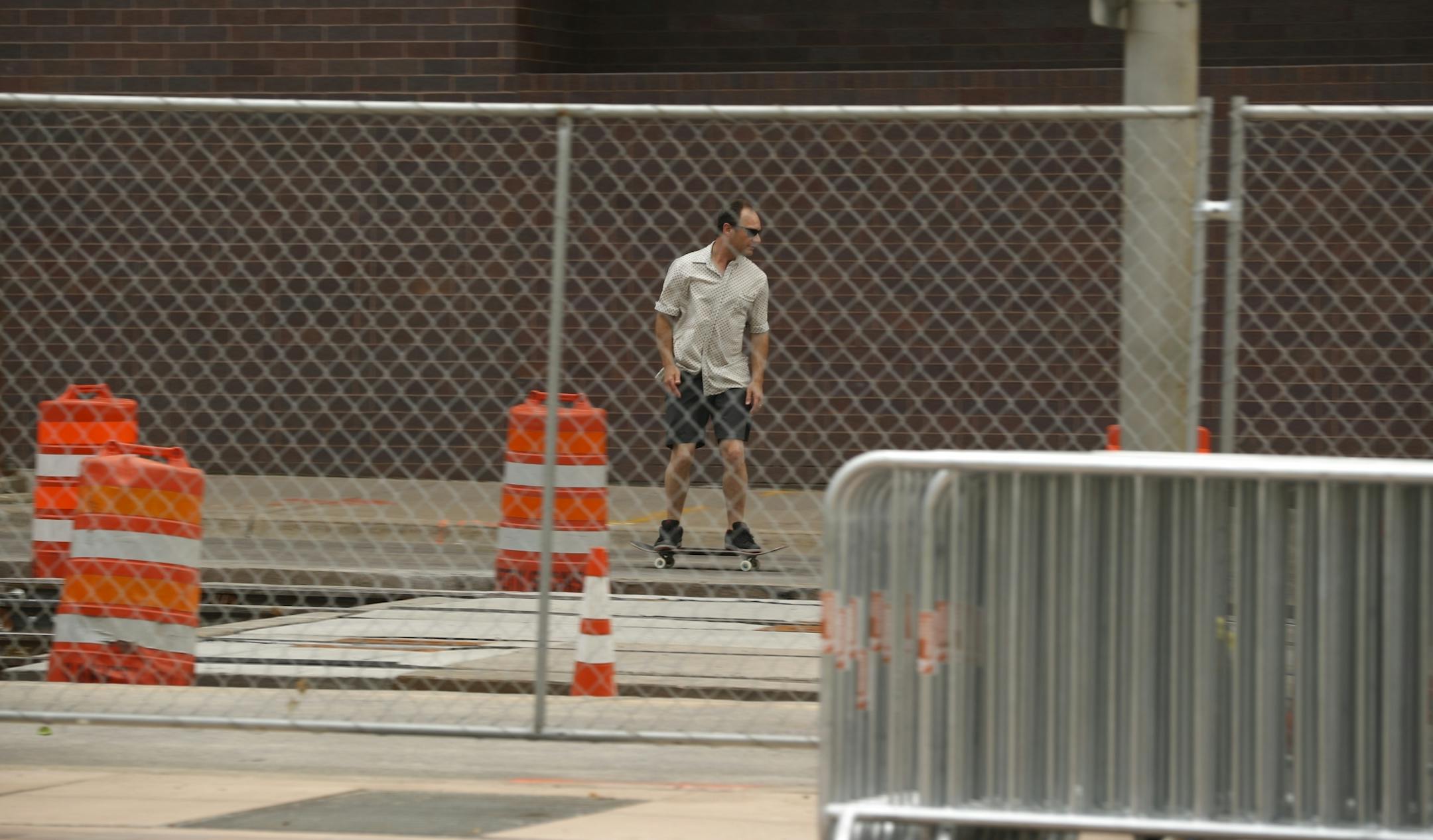 Chain link fencing surrounds The Commons Park across from U.S. Bank Stadium.