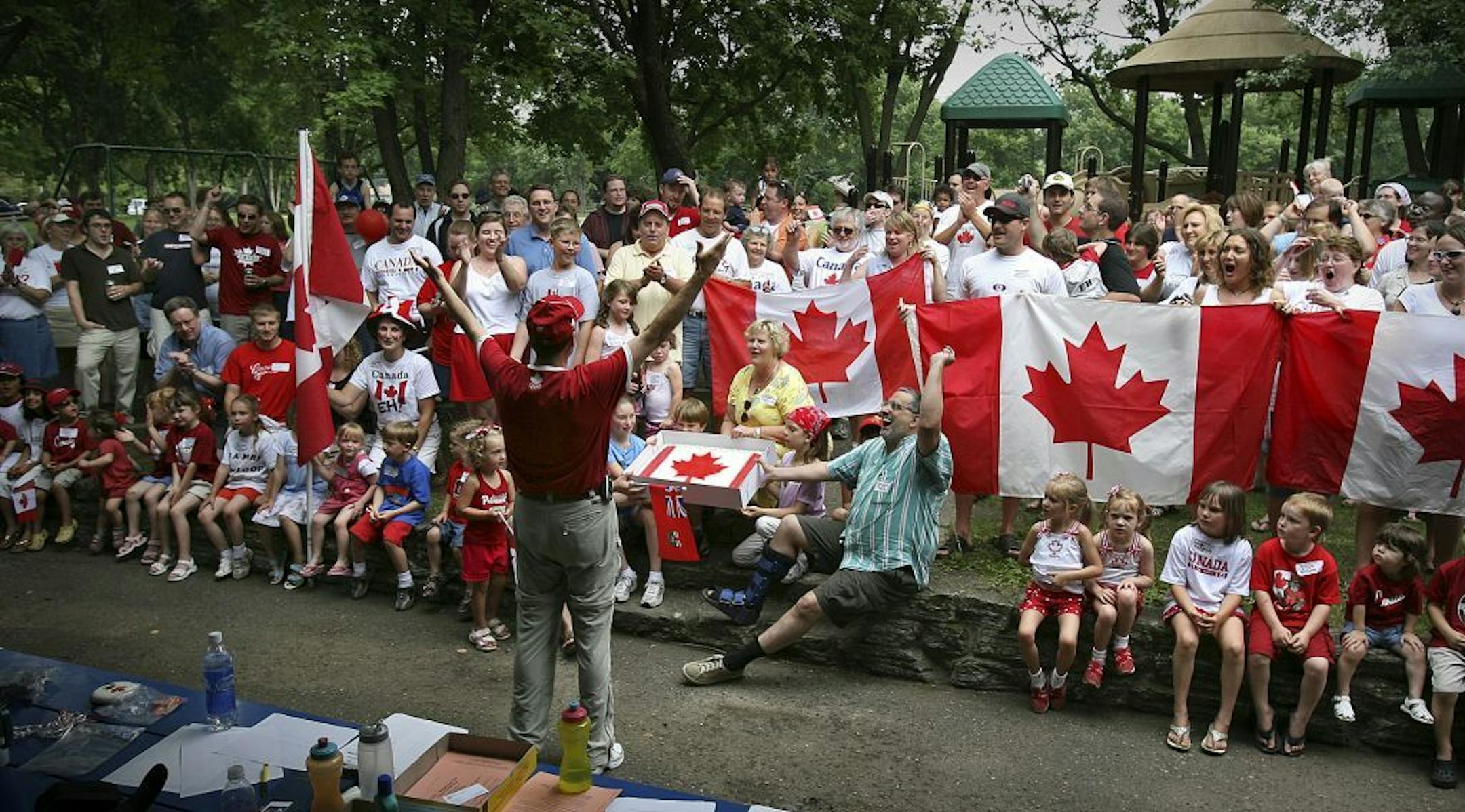 DAVID JOLES djoles@startribune.com Bloomington, MN-July 1, 2006-Canadian Richard Ulrich, with the Canadian Consulate General in the Twin Cities, leads Canadians now living in Minnesota, their families and Canadian wannabees in the singing of "Oh Canada," during the annual Canada Day picnic at Moir Park in Bloomington, MN Saturday, July 1, 2006.